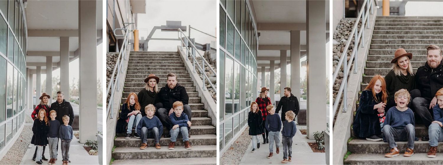 A family of five, including two children and two adults, sitting on outdoor concrete stairs with metal railings, in an urban setting.