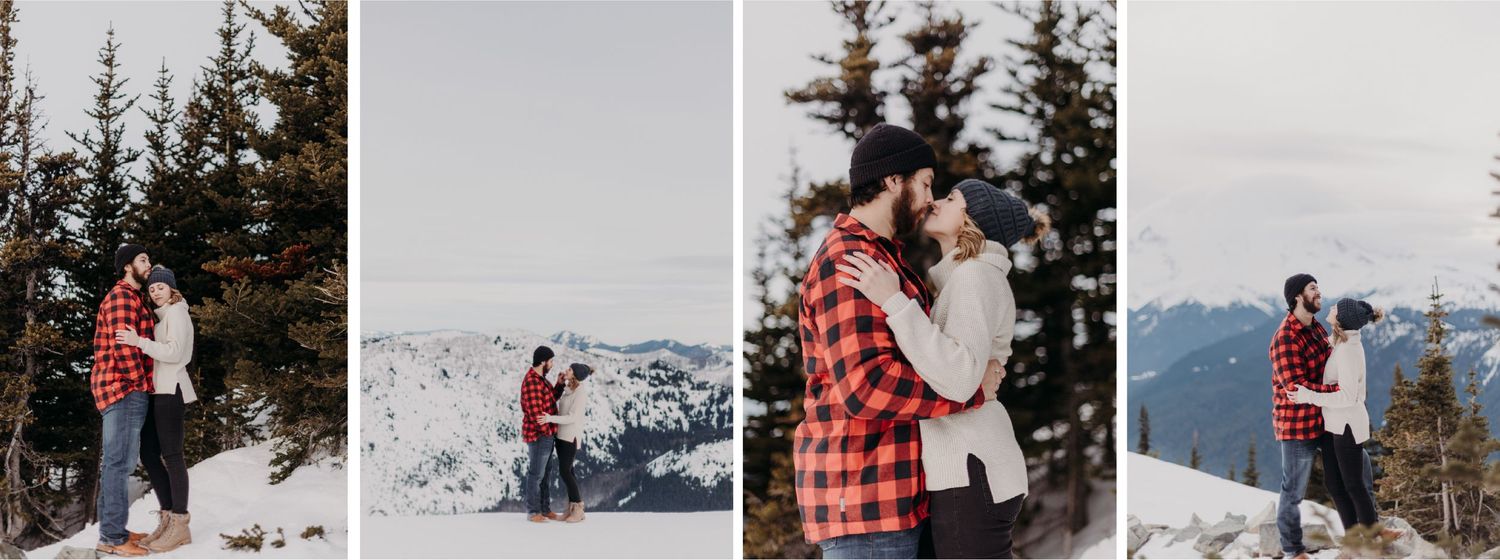 A man and a woman standing on a mountain top surrounded by trees and snow.
