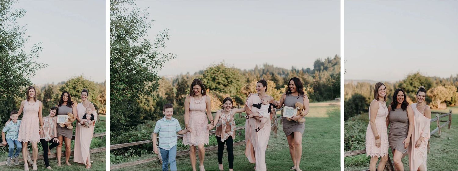 Group of women and children walking in a park, smiling, with trees and a fence in the background.