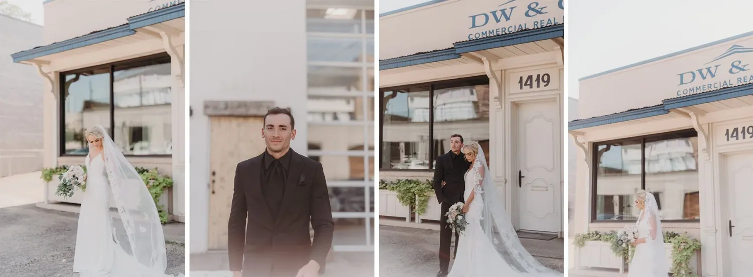 A man and a woman standing in front of an urban building on their wedding day as the sun sets.