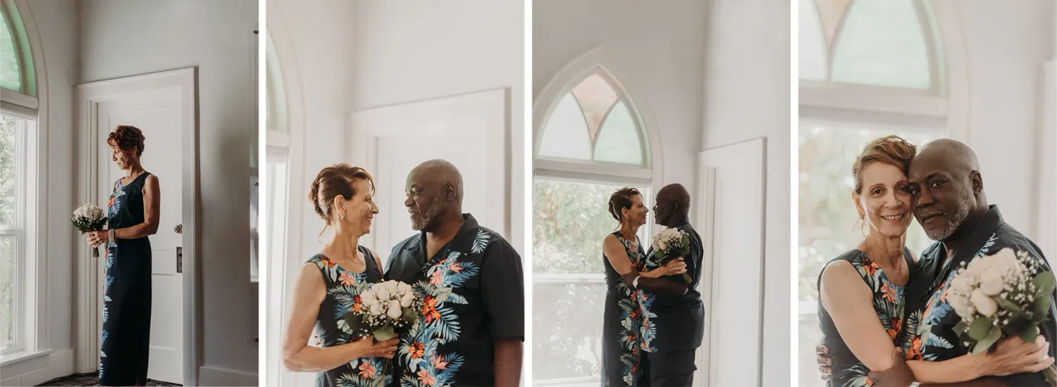 A man and a woman holding each other in an old church with stained glass windows on their wedding day.