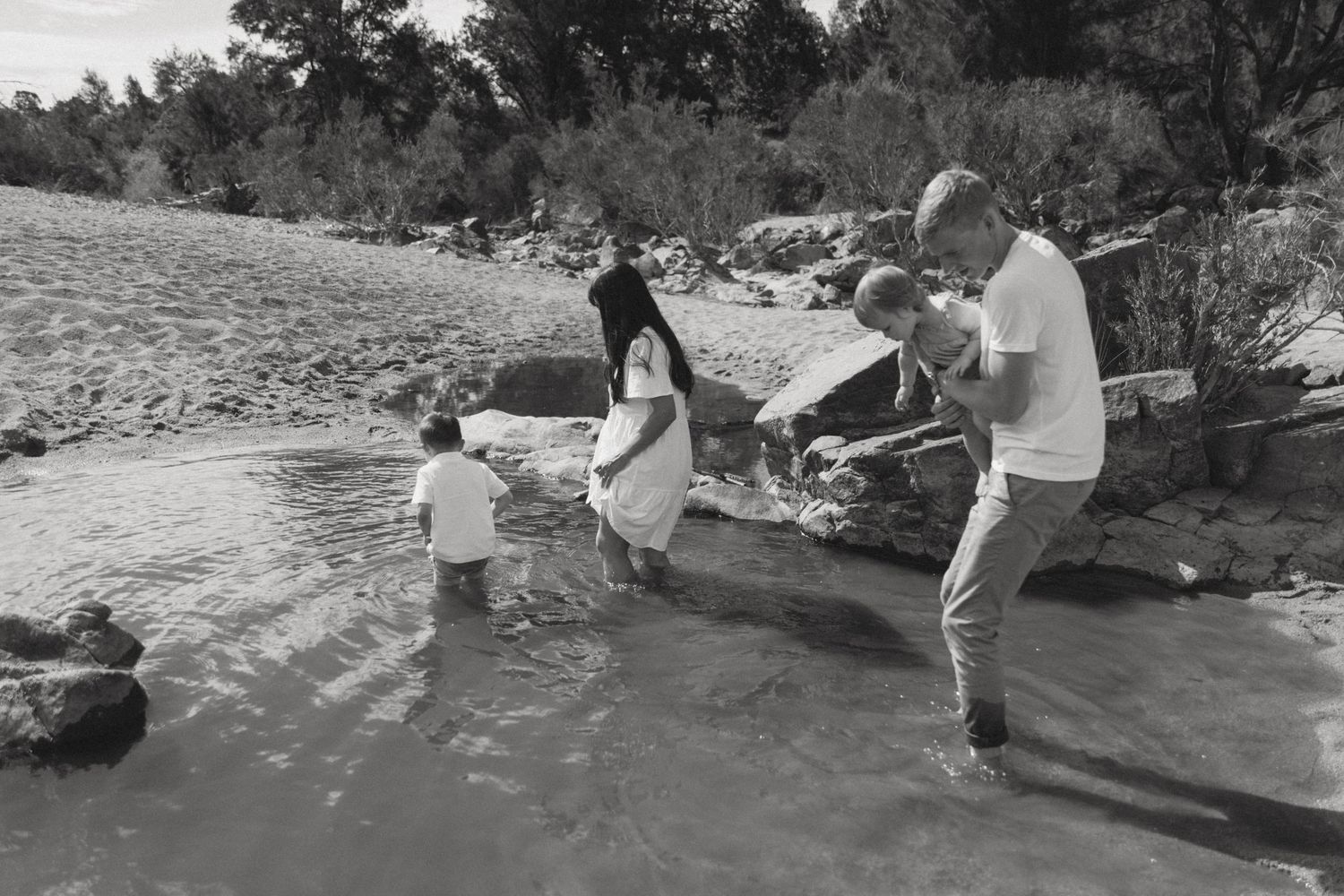 Parents laughing with their children during a relaxed family photography session