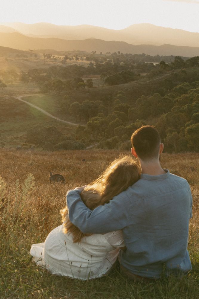 Newly engaged couple watching the sunset