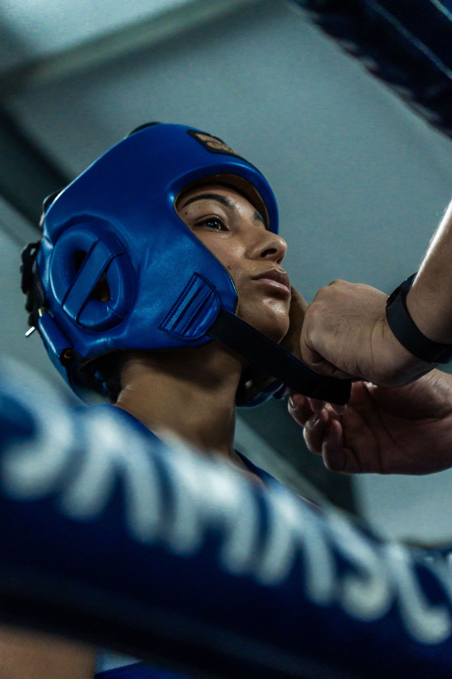 Close-up portrait of a boxer wearing blue headgear during a boxing event, captured by a Cape Town sports photographer.