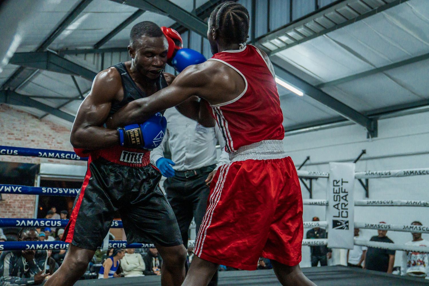 Two boxers competing in the ring during a live boxing event, captured through professional sports photography in Cape Town.