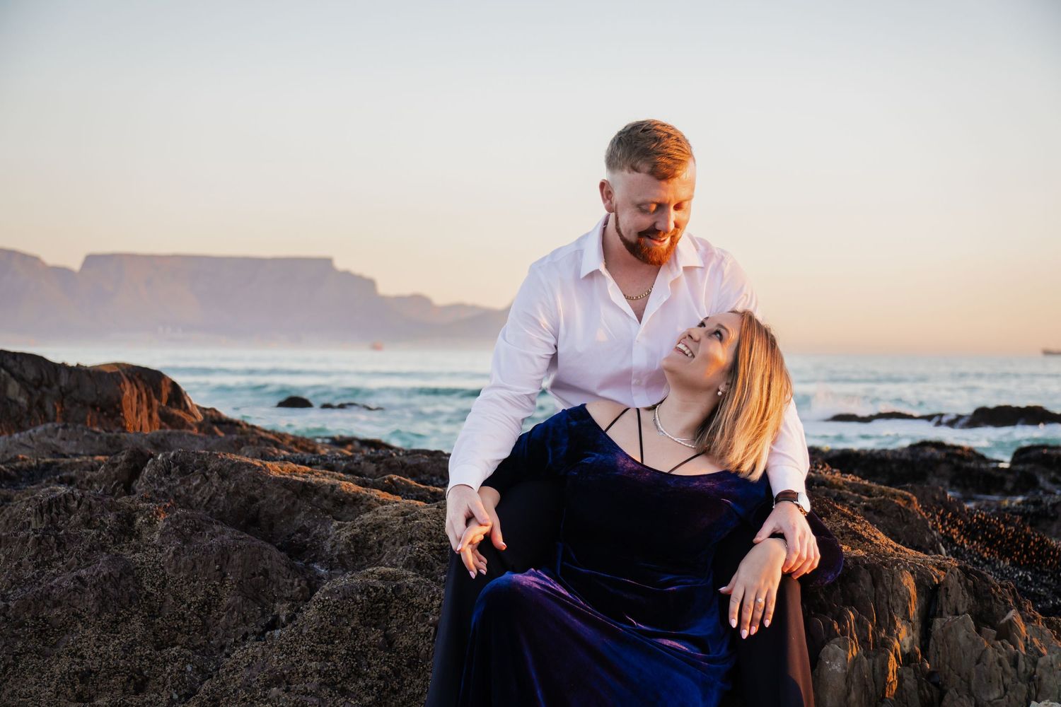 Couple portrait at sunset with Table Mountain in the background during an outdoor photography session in Cape Town.