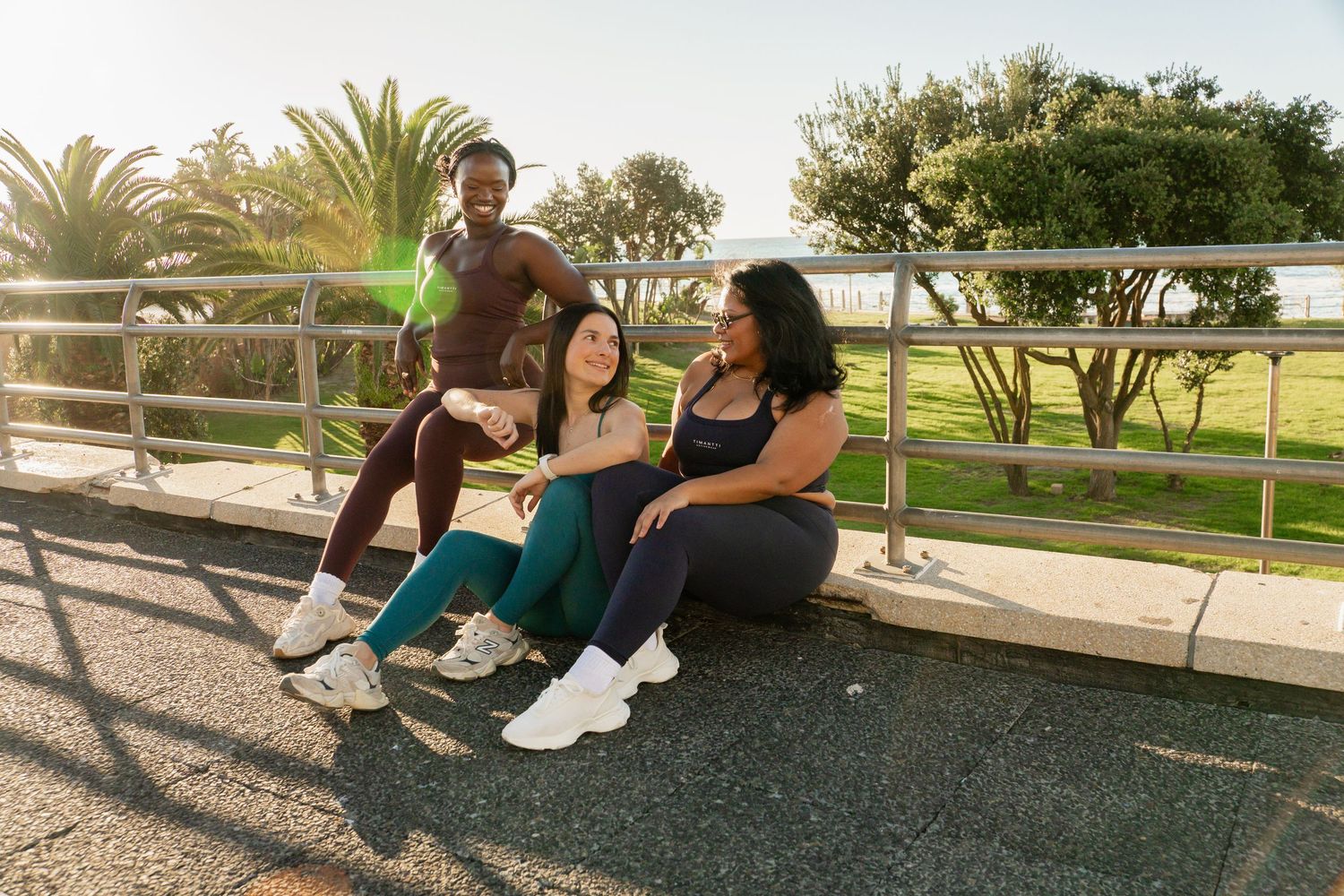 Female athletes together after an outdoor fitness session in Sea Point, Cape Town, photographed by Charlene Vrey Photography.