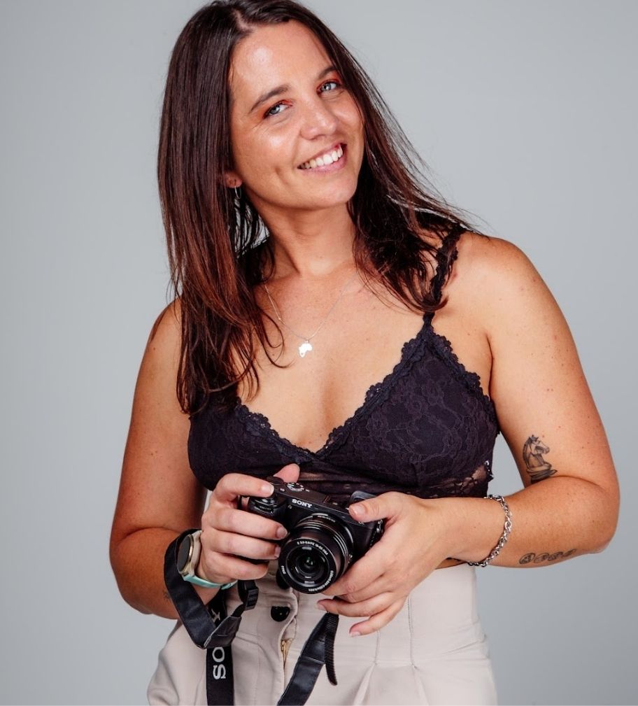 Cape Town photographer Charlene Vrey holding her camera, specialising in portrait, fitness, lifestyle and event photography.