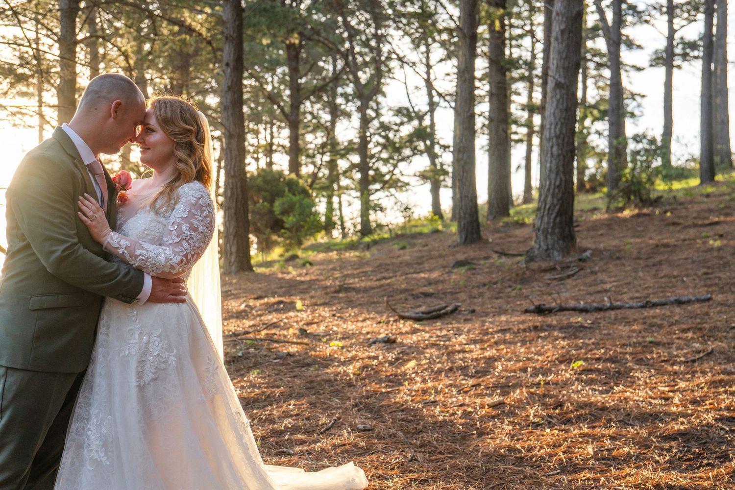 Bride and groom sharing an intimate moment among the trees during an outdoor wedding photography session in Cape Town.