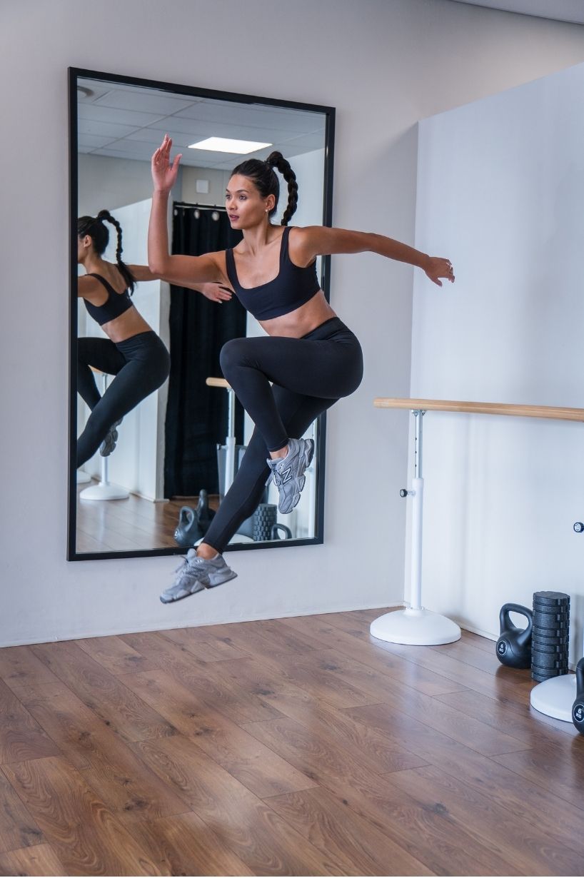 Female athlete training indoors during a strength and fitness session, photographed by Charlene Vrey Photography in Cape Town.