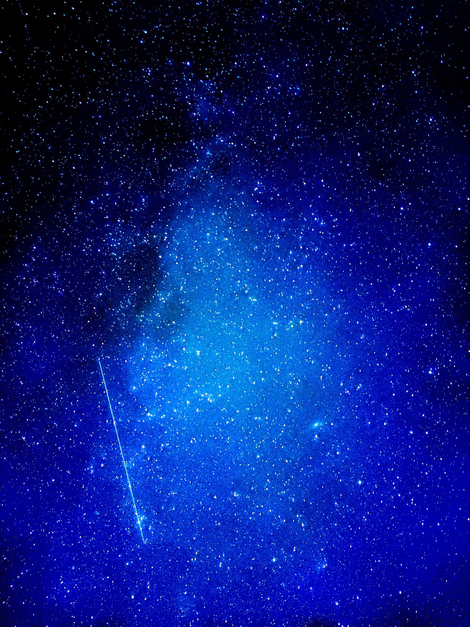 A picture of stars and space with a meteor