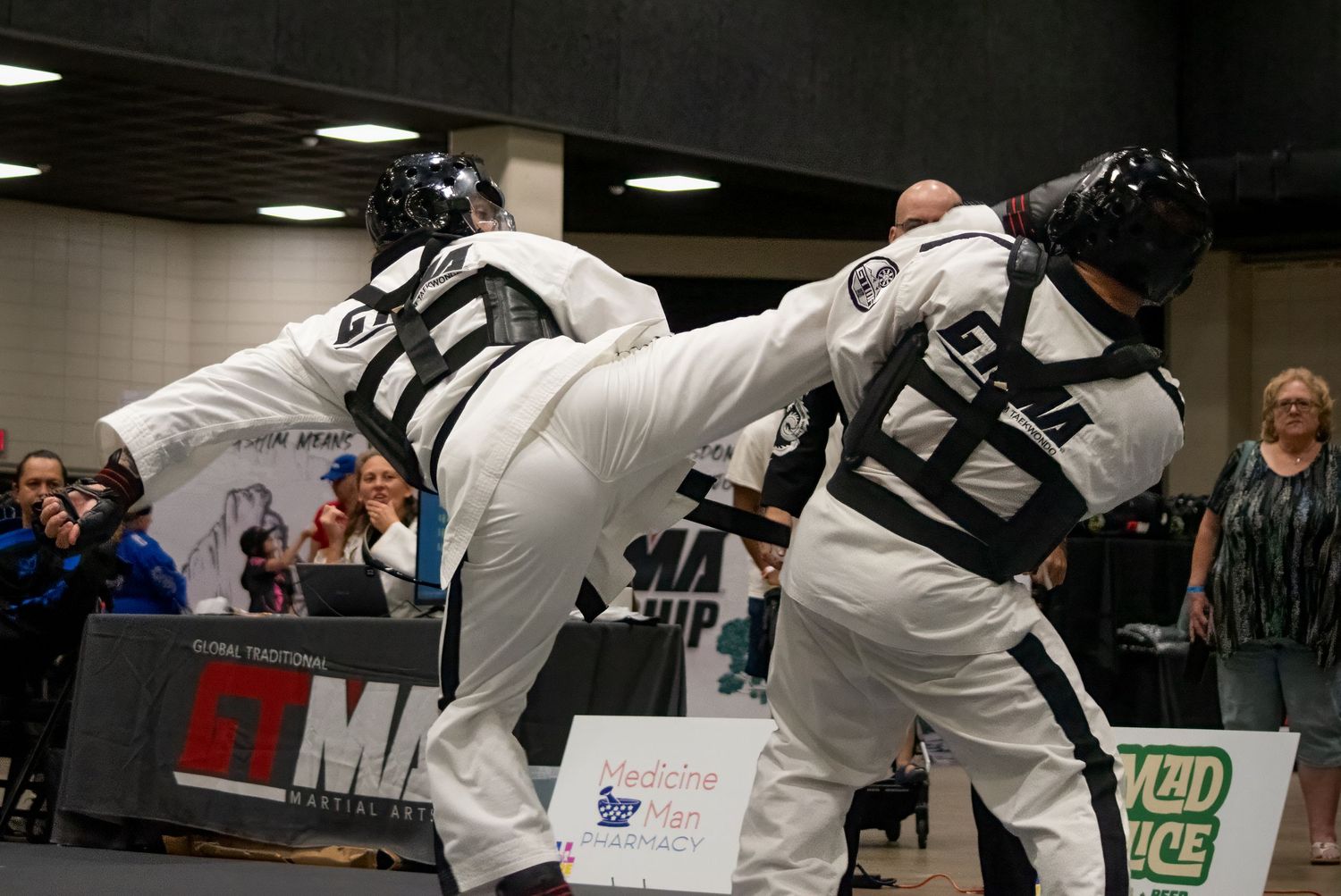 Taekwondo action photography of martial artists sparring at a tournament in Gretna, Nebraska