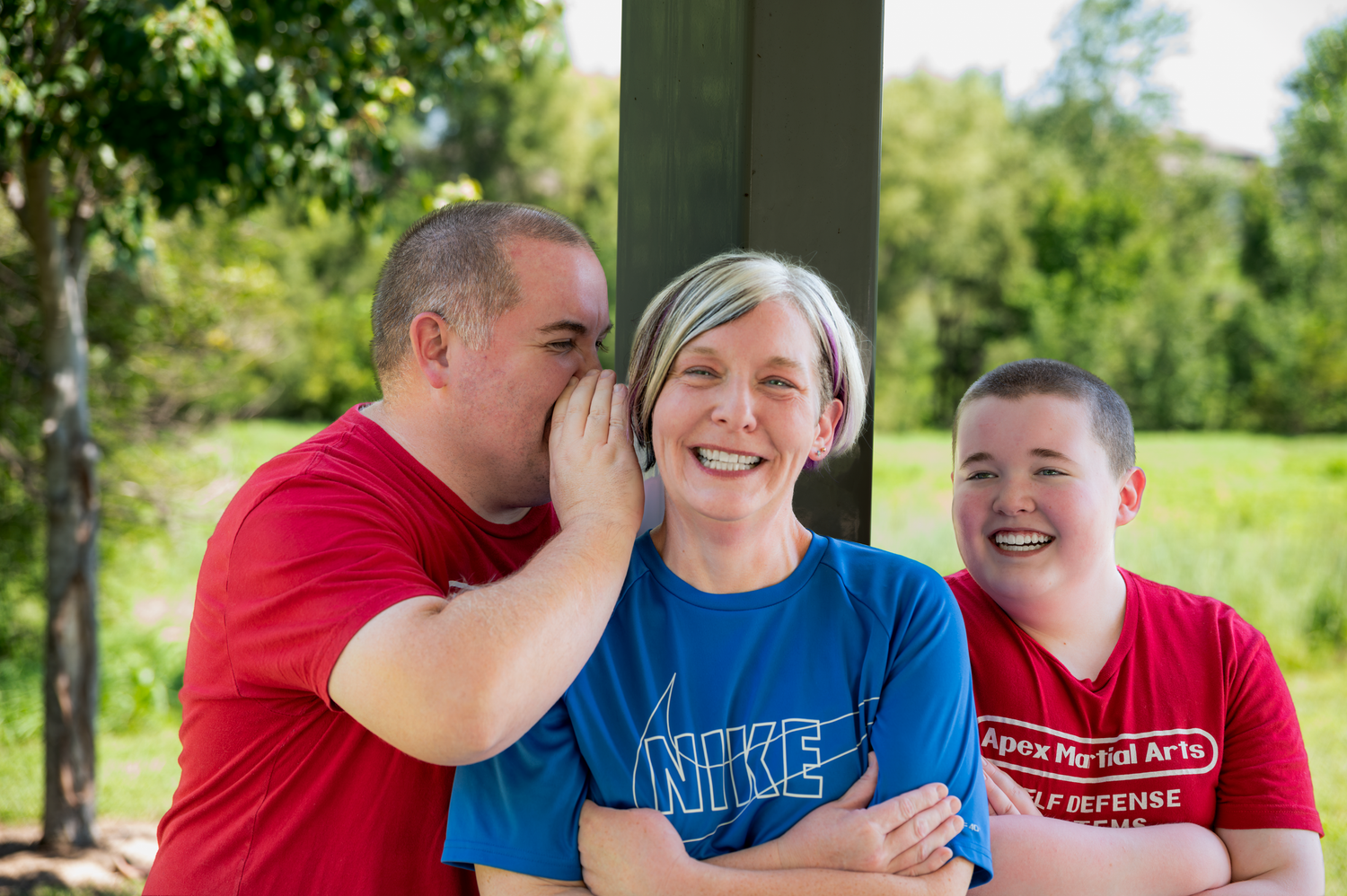 Candid family laughing and whispering during a portrait session at Prairie Queen in Papillion