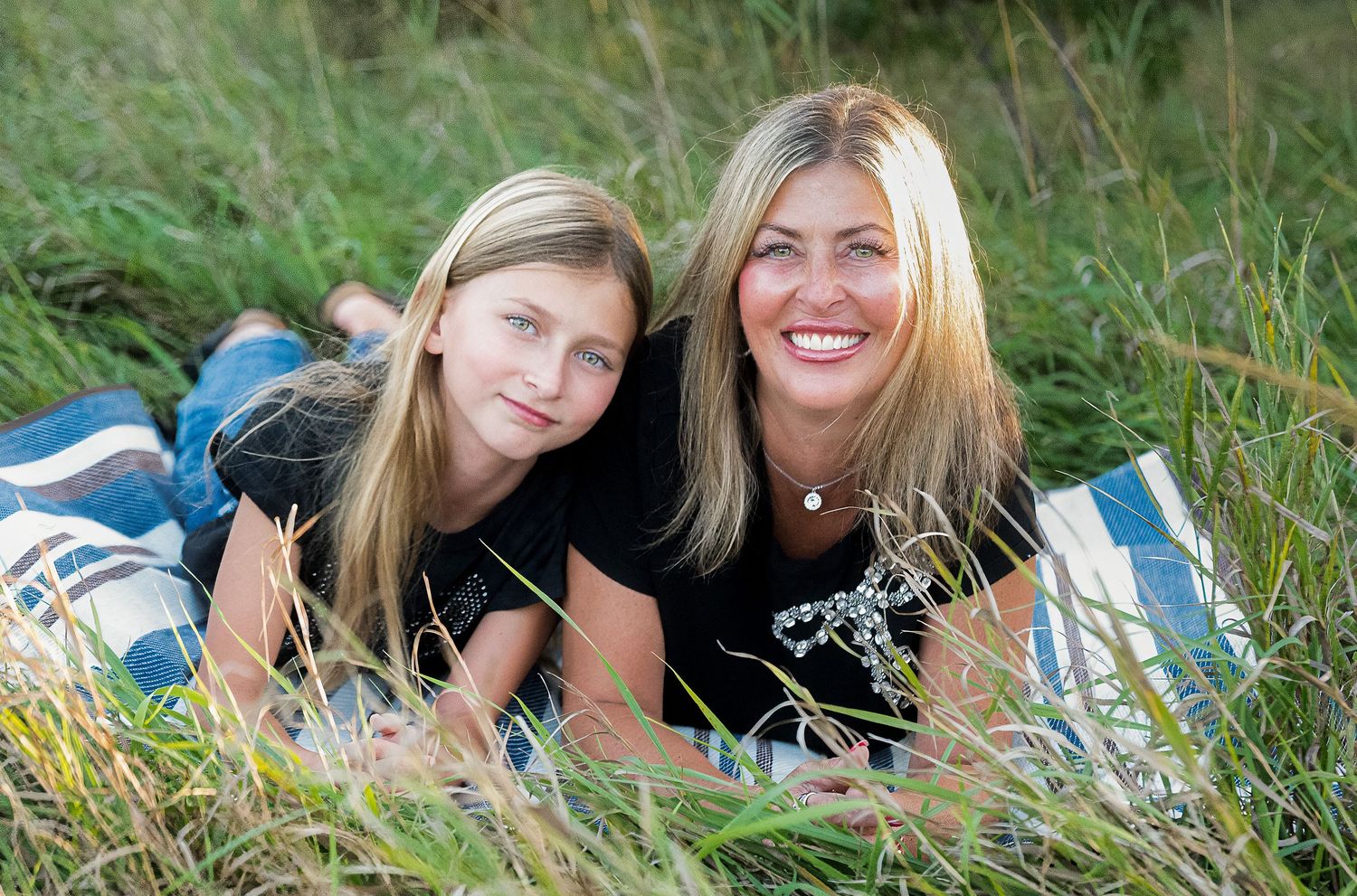 Mother and daughter relaxing together during an outdoor portrait session at Chalco Hills in Omaha