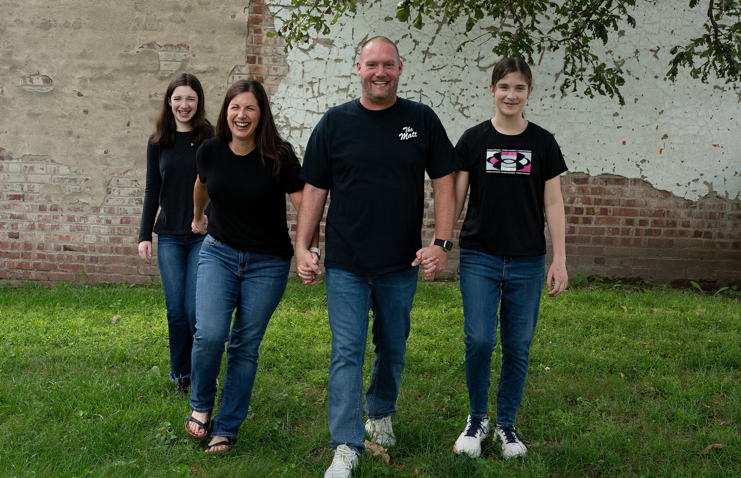 Candid family walking together during a portrait session in downtown Gretna, Nebraska