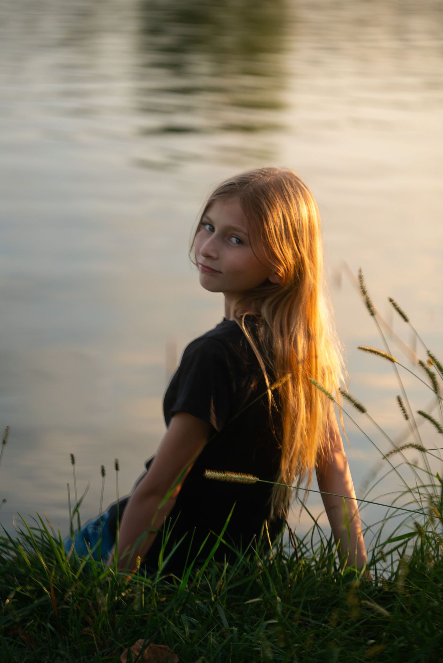 Child portrait by the water at sunset at Chalco Hills Recreation Area in Omaha