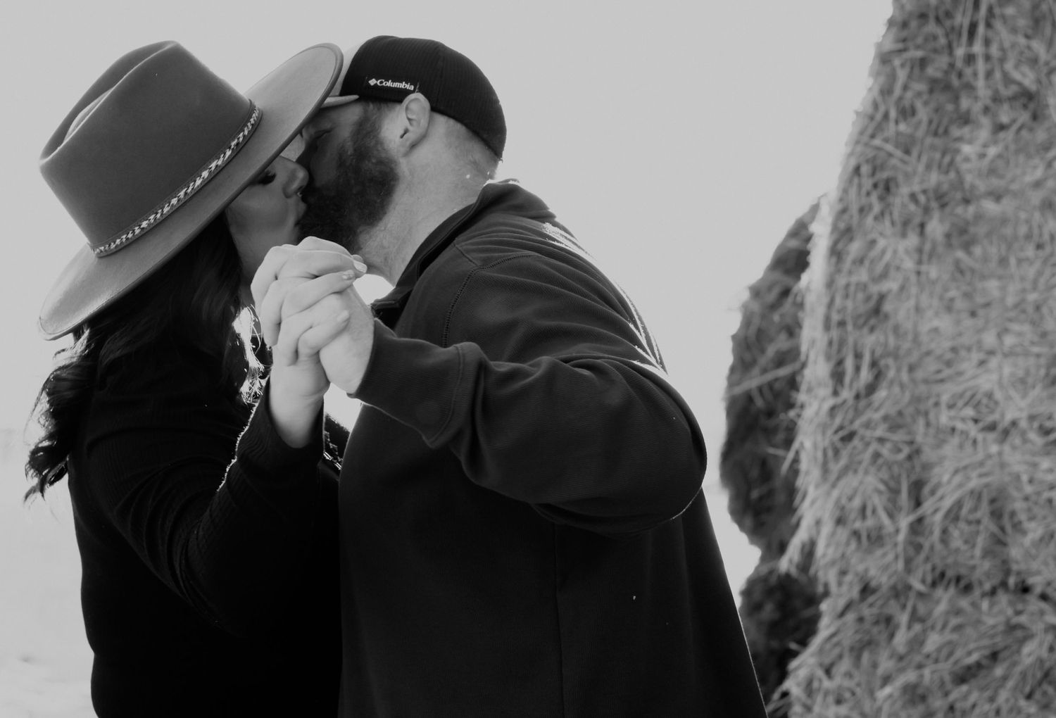 Couple sharing an intimate dance moment while wearing winter coats and a hat.