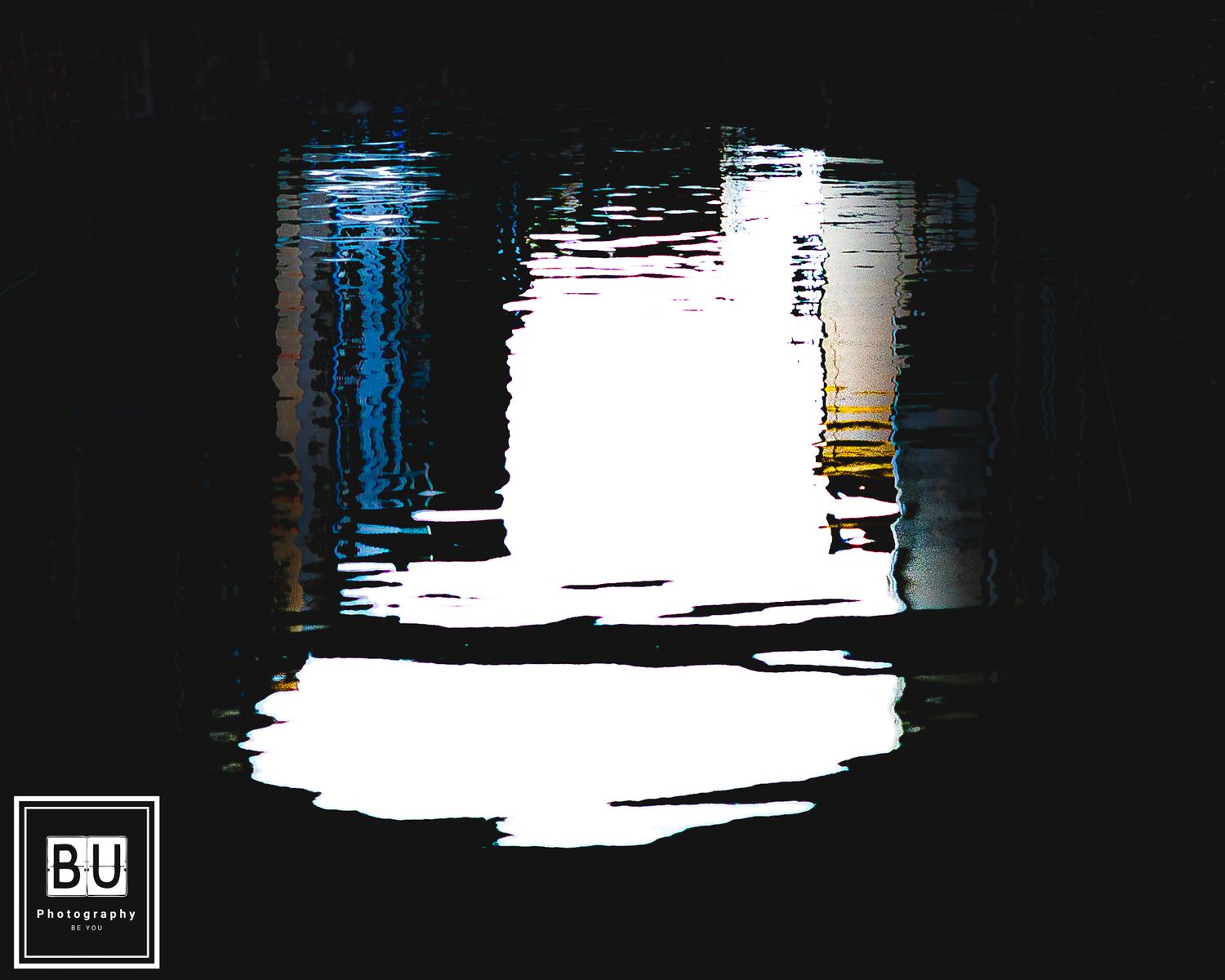 Abstract black and white modern art with blue and yellow accents against a dark background.