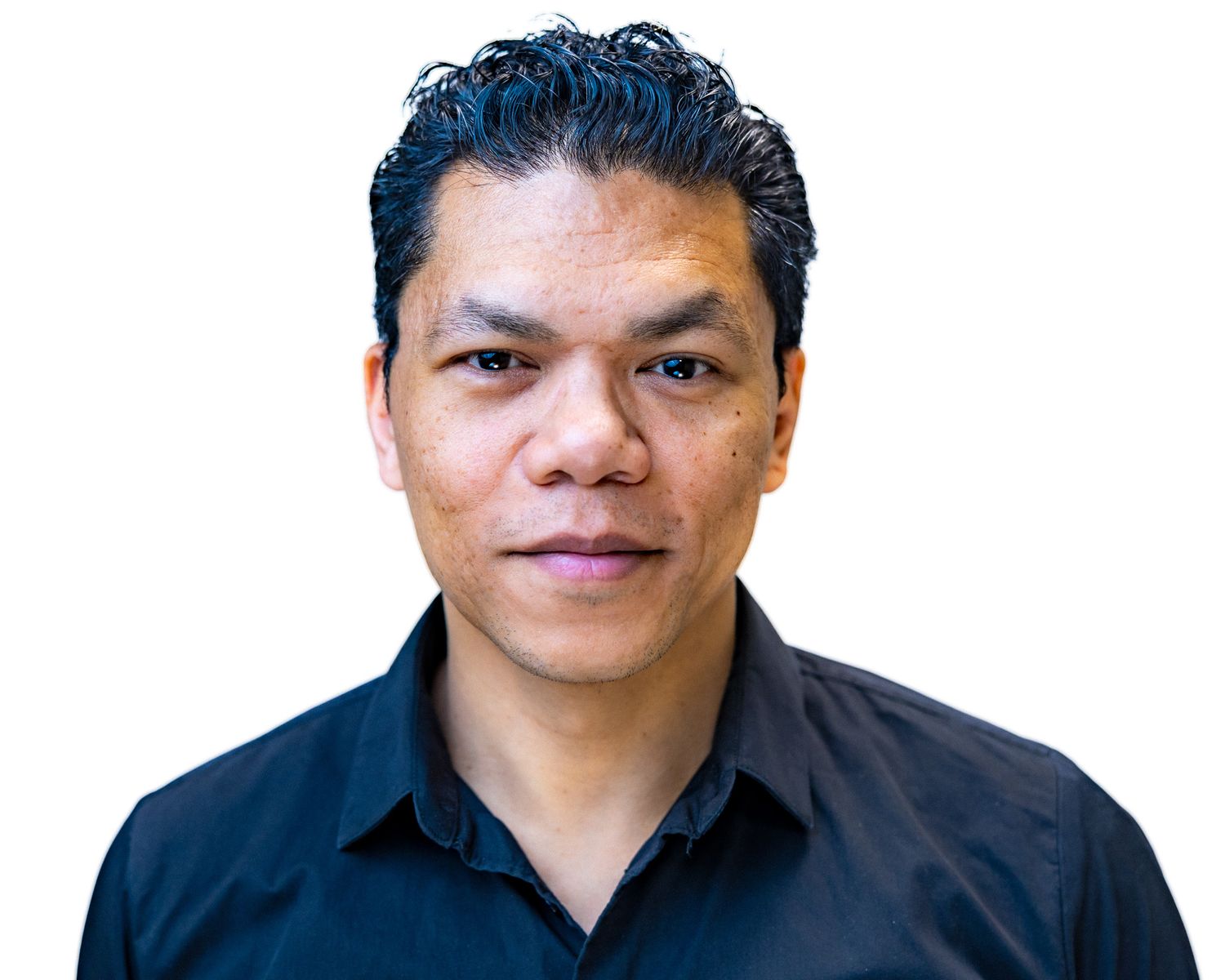 Professional headshot of person in dark button-down shirt against white background.