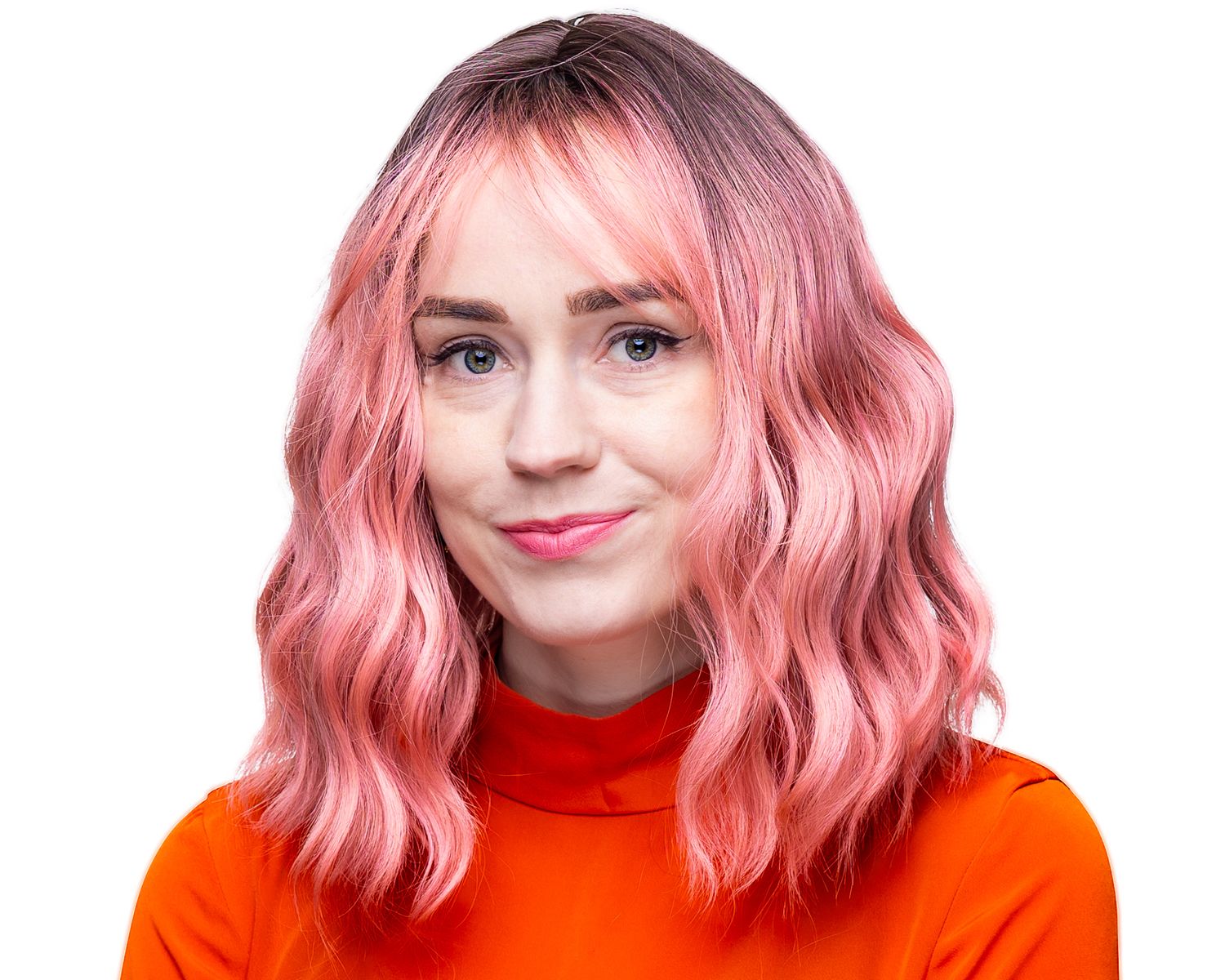 Portrait of someone with wavy pink hair wearing a bright orange turtleneck sweater against a white background.