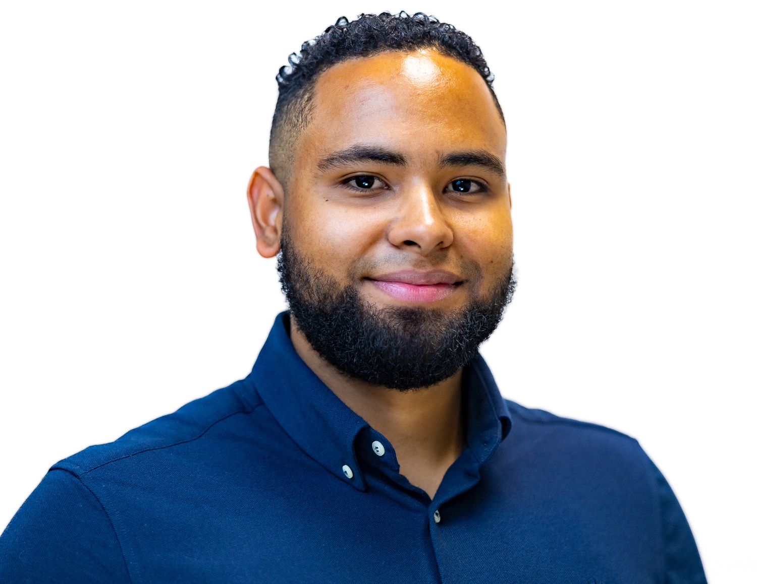 Professional headshot of a person with a beard wearing a navy blue collared shirt against a white background.