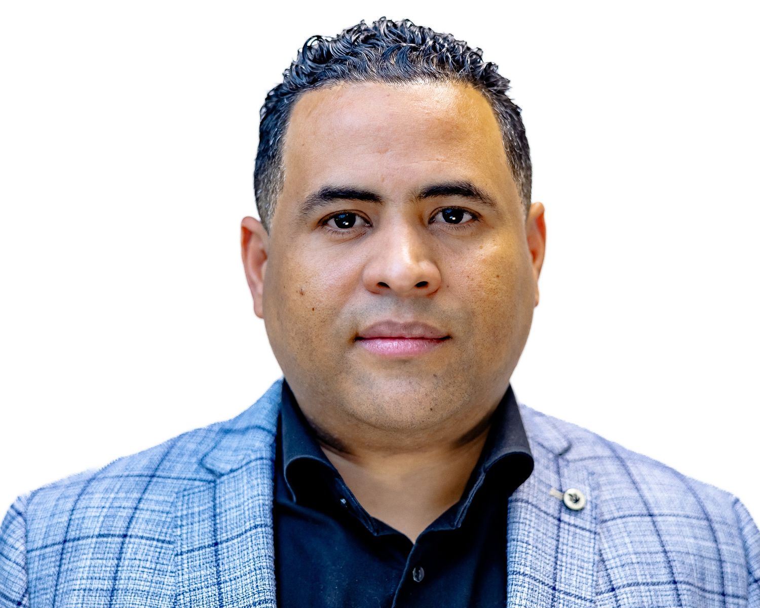 Professional headshot of someone wearing a light blue blazer and black shirt against a white background.