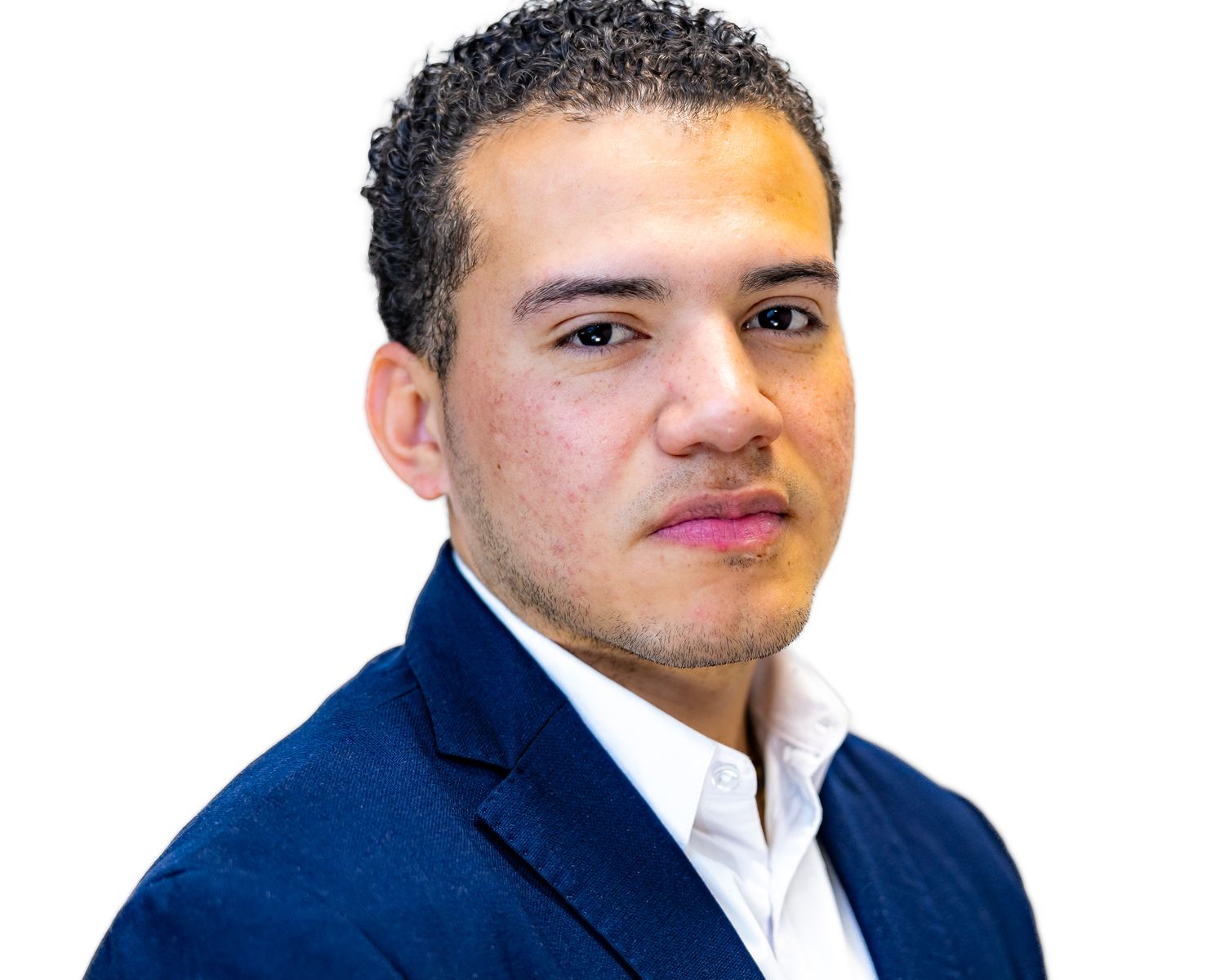 Professional headshot of someone wearing a navy blue suit jacket and white dress shirt against a white background.