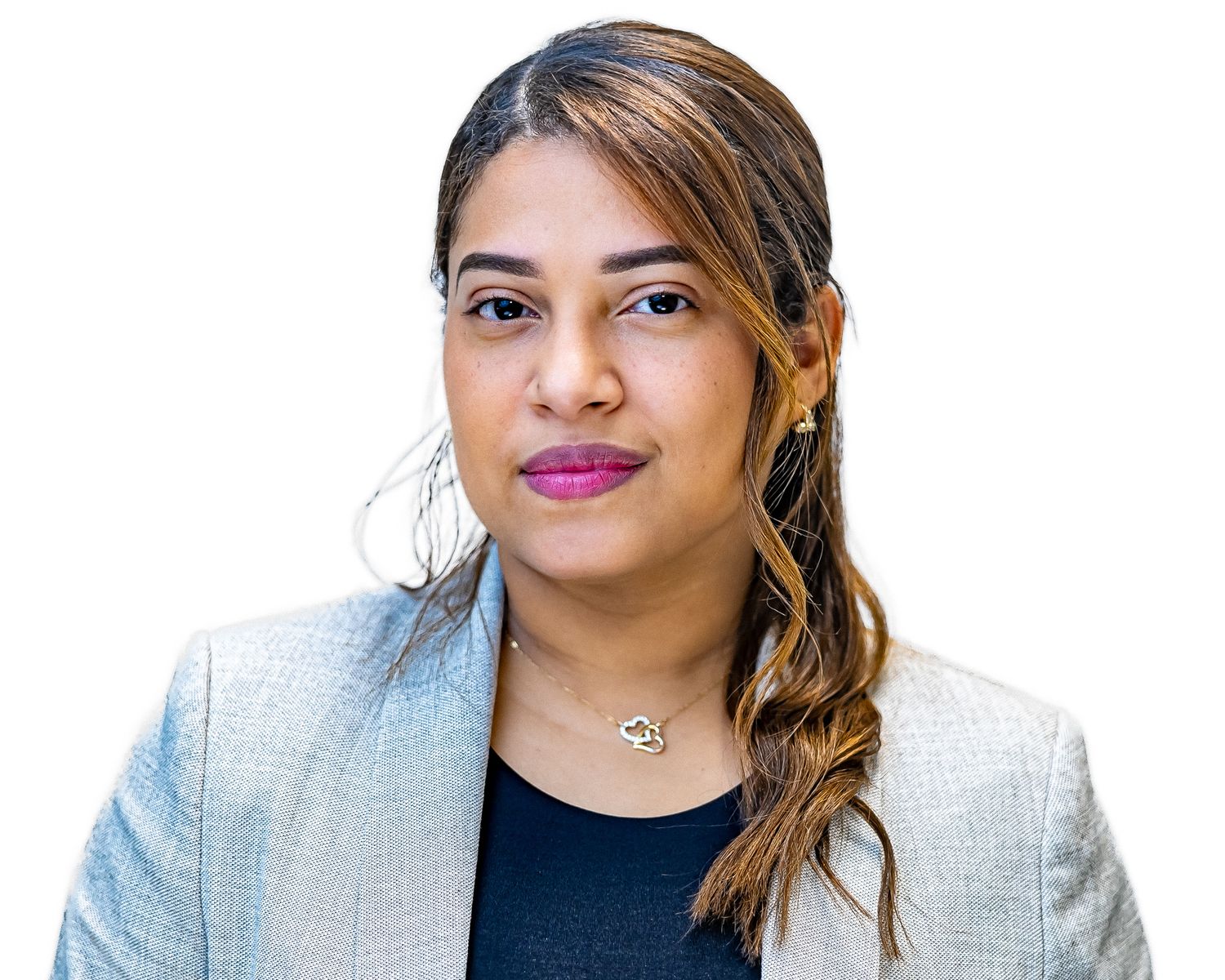 Professional headshot against white background showing person in blazer with long hair styled in side braid.