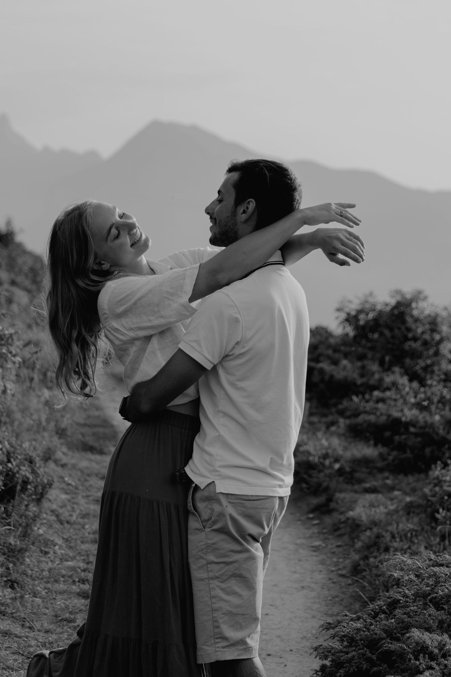 A romantic black and white photo series showing intimate moments in a mountain setting.