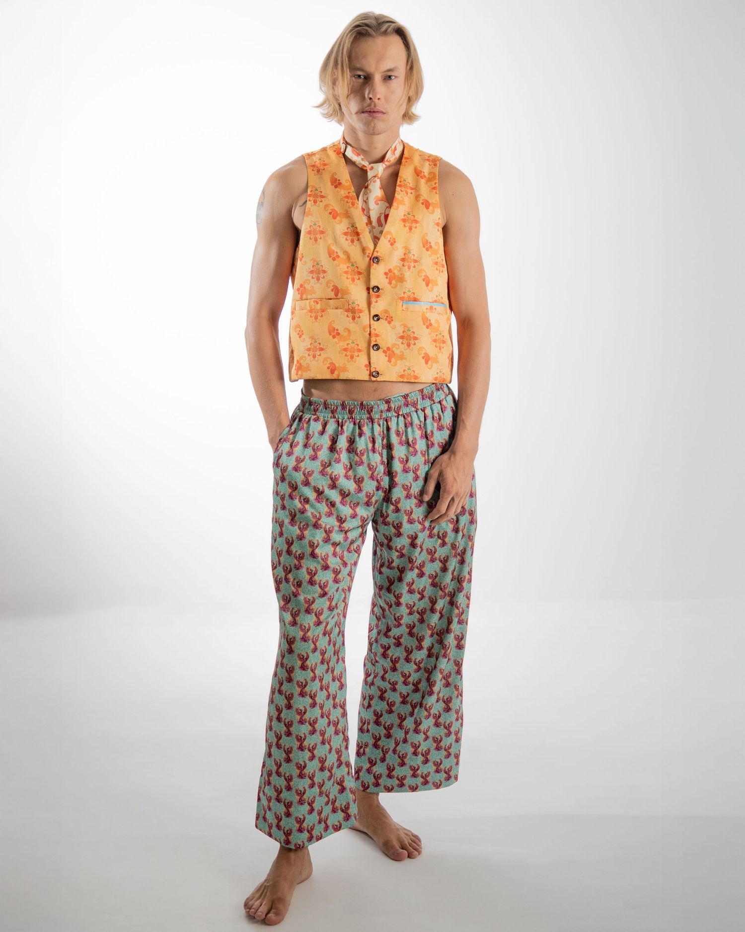 A person in a peach sleeveless top and patterned wide-leg pants shown from four different angles against a white backdrop.
