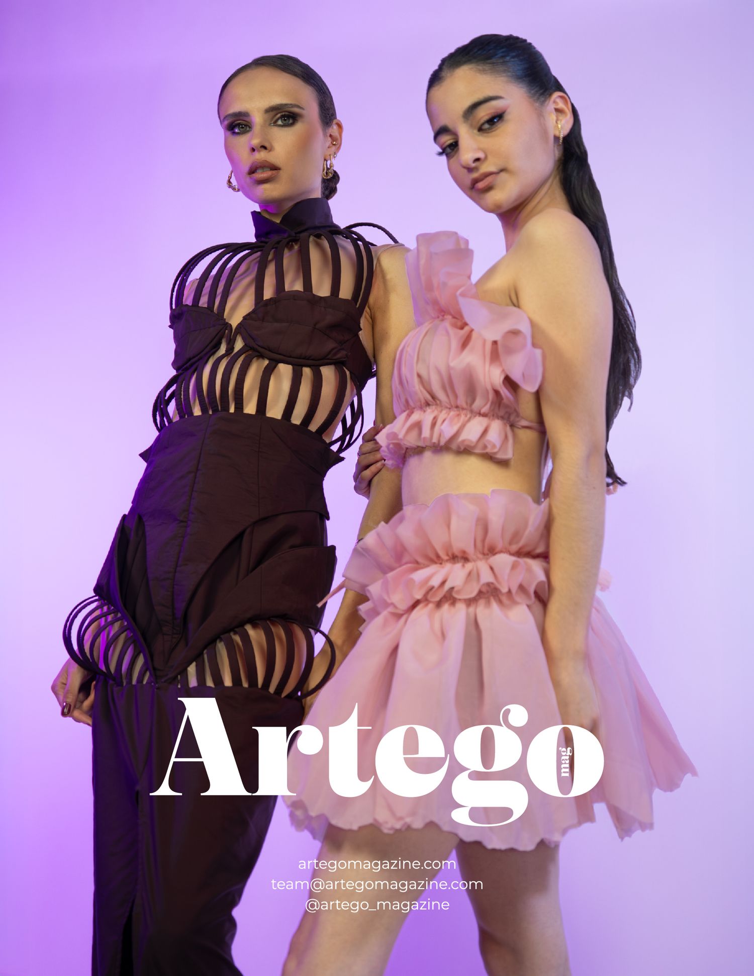 Two models showcase contrasting black and pink designer dresses in editorial photoshoot.