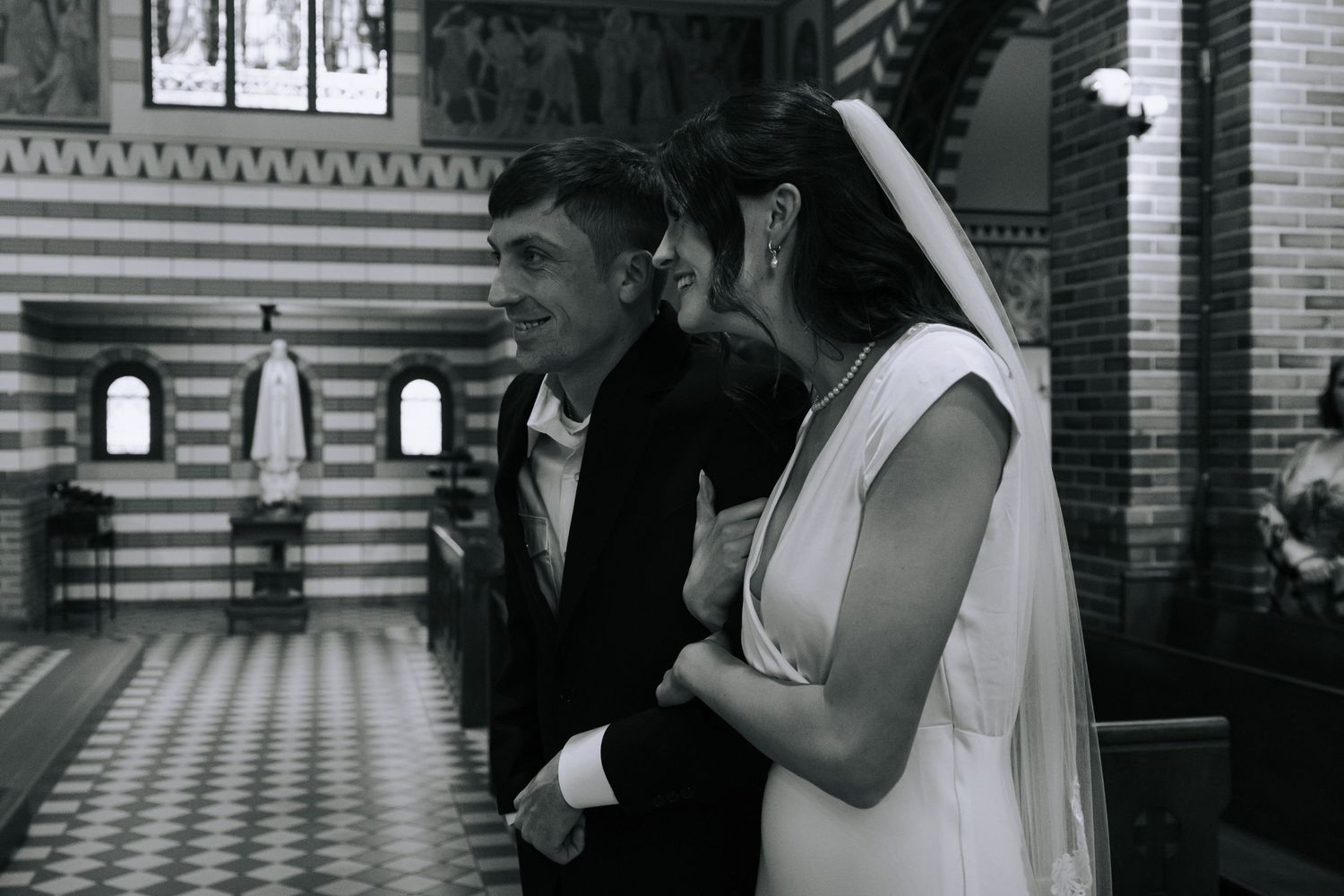 A black and white photo collage showing multiple views of a bride and groom during their wedding ceremony.