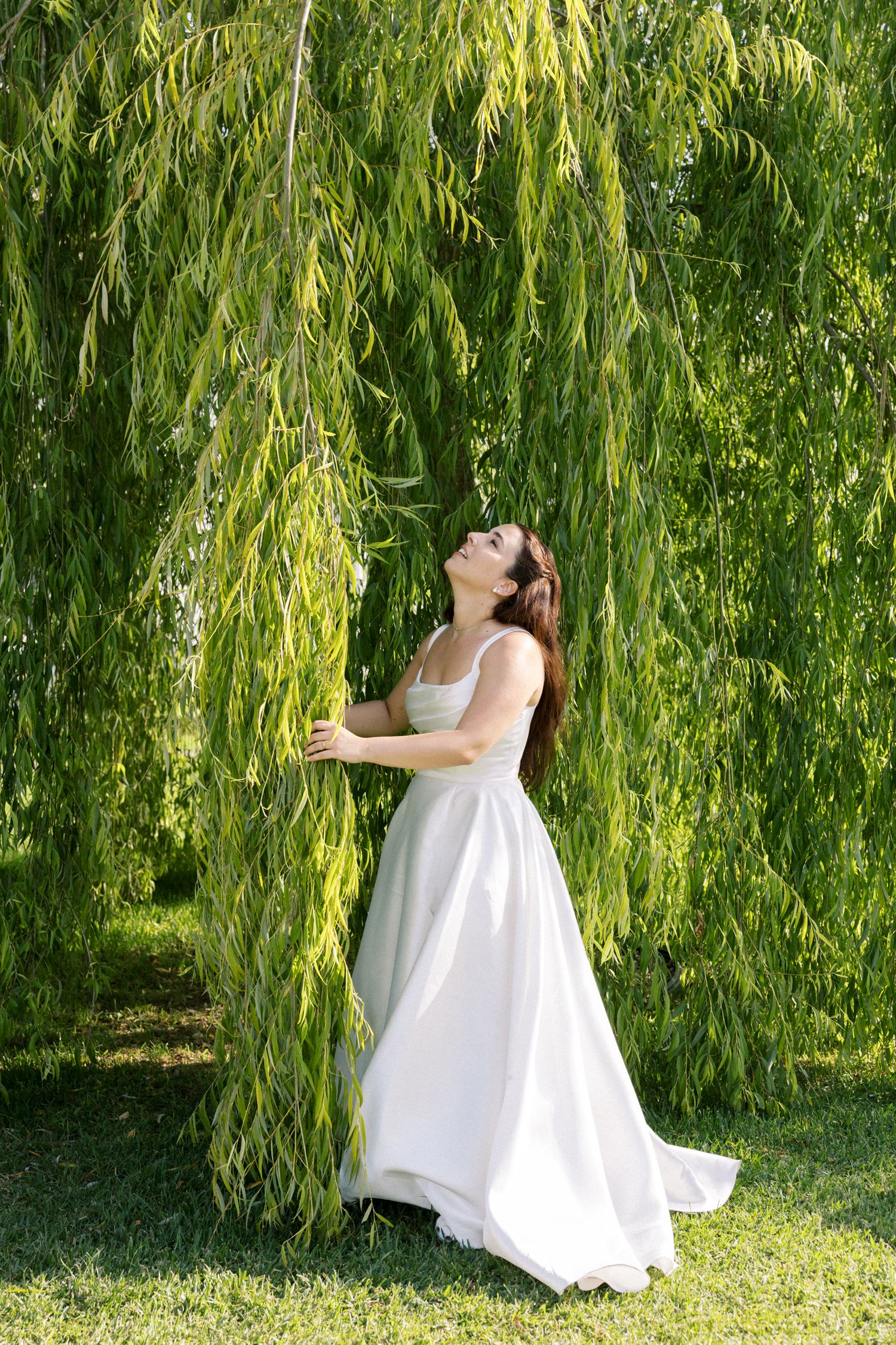 Elegant bride portrait under willow tree garden at Palácio da Bacalhôa destination wedding