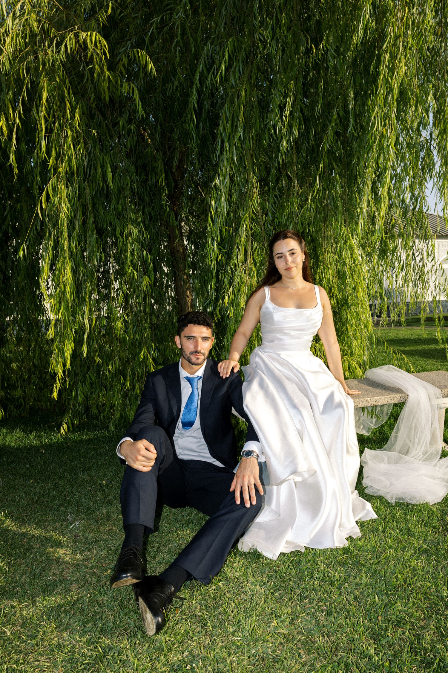 Elegant wedding couple seated in garden at Palácio da Bacalhôa destination wedding