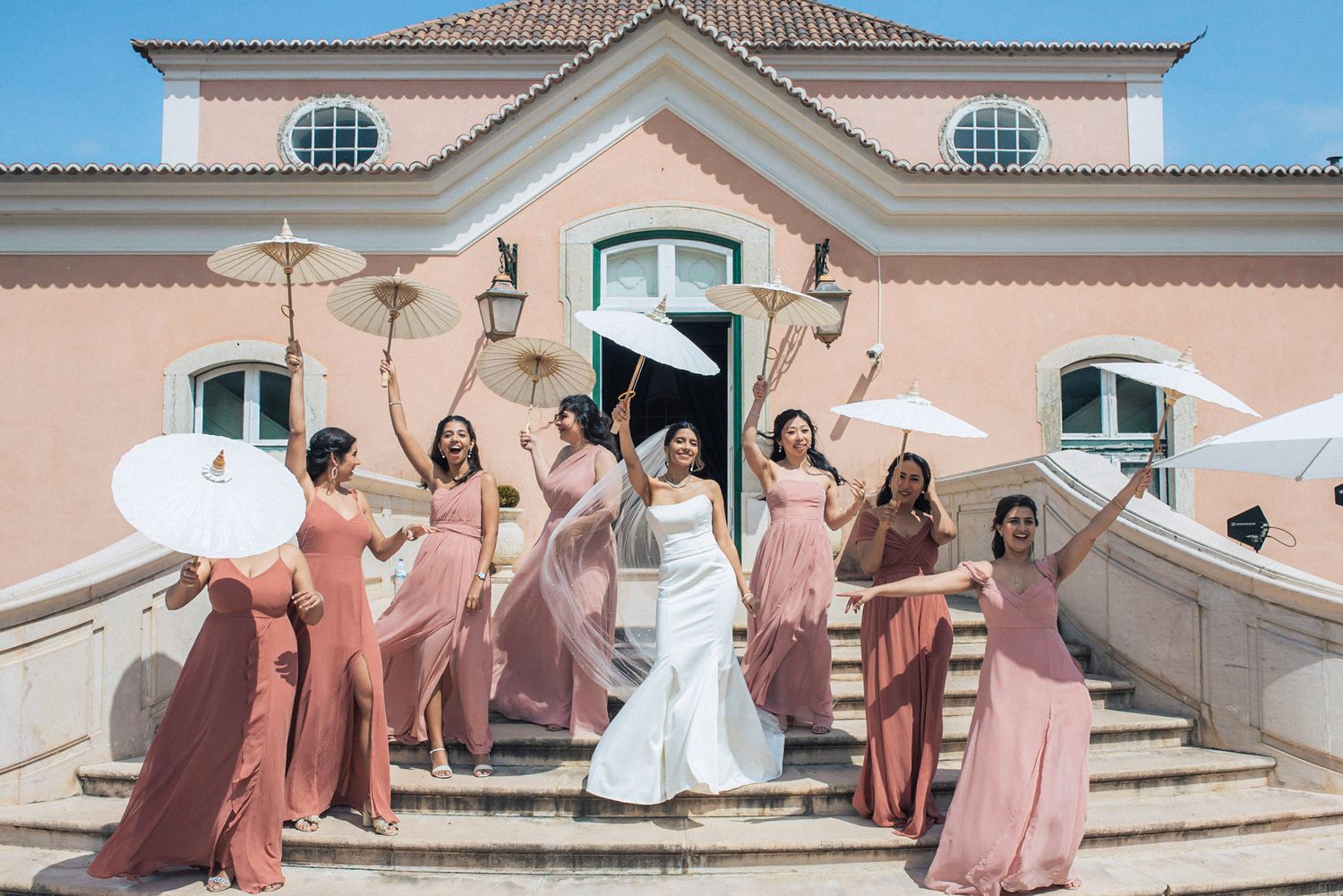 Bridesmaids in pink dresses celebrating, photographed by an Indian destination wedding photographer in Portugal – Correio Mor Palace