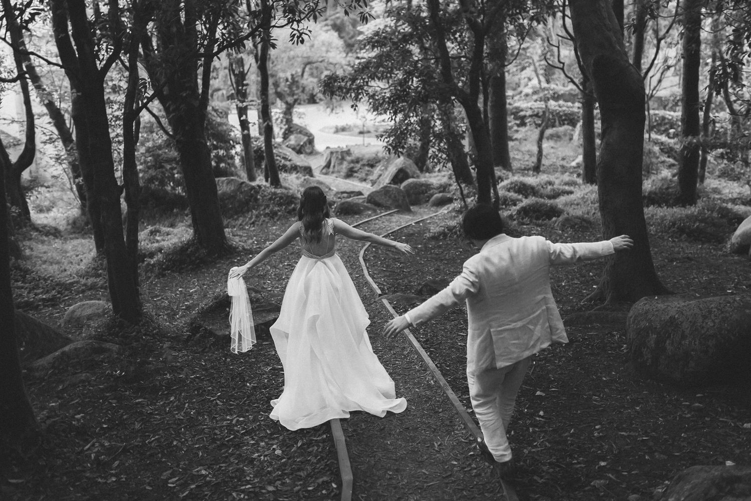 Black and white newlyweds walking through Sintra forest during destination wedding in Portugal