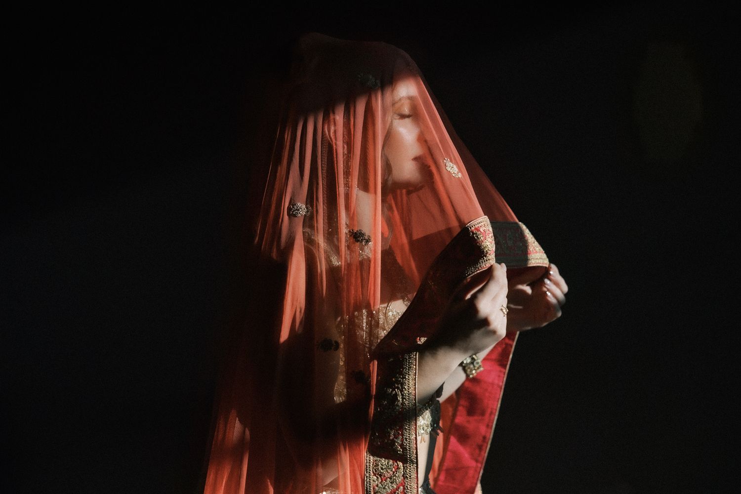 Indian bride editorial portrait with a red dupatta
