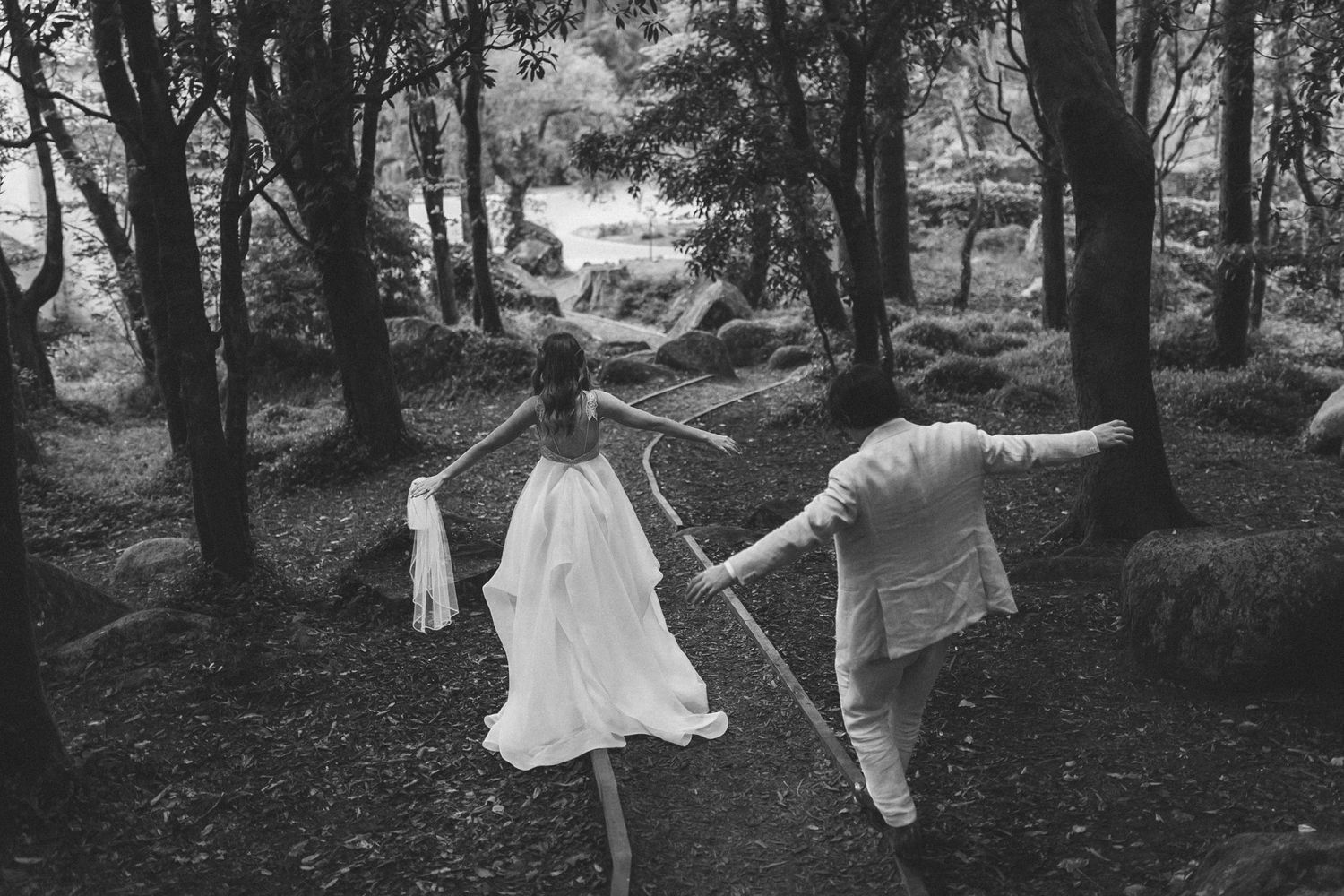 Bride and groom exploring nature in Portugal – romantic destination wedding captured in timeless black and white.