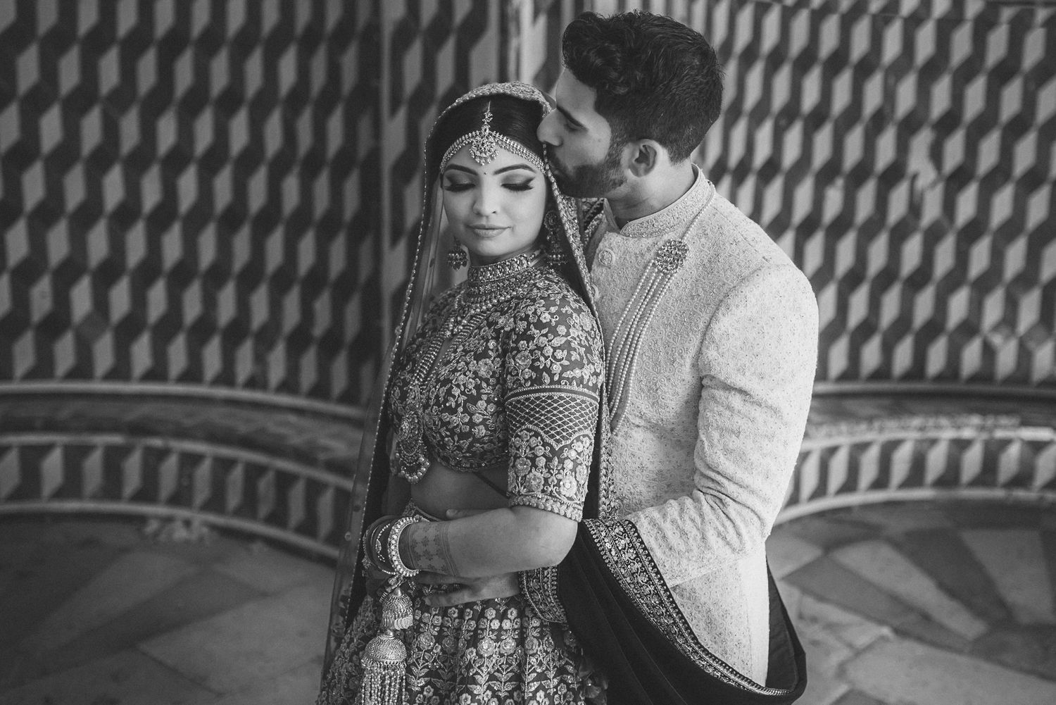Elegant Indian bride and groom in traditional attire during their destination wedding in Portugal