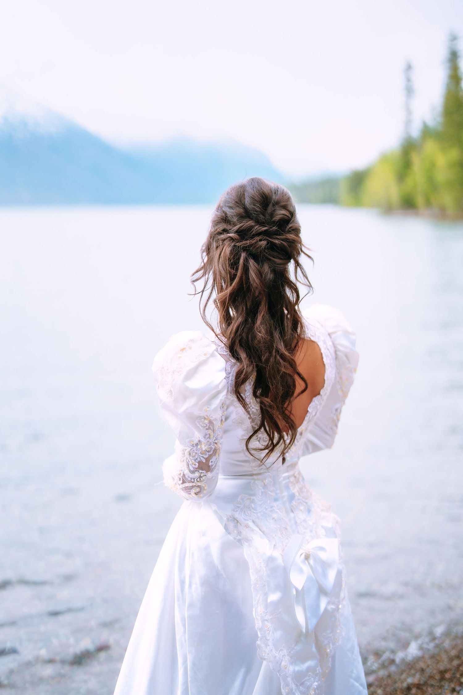 Bride standing in Lake McDonald during a Glacier National Park elopement photography session.