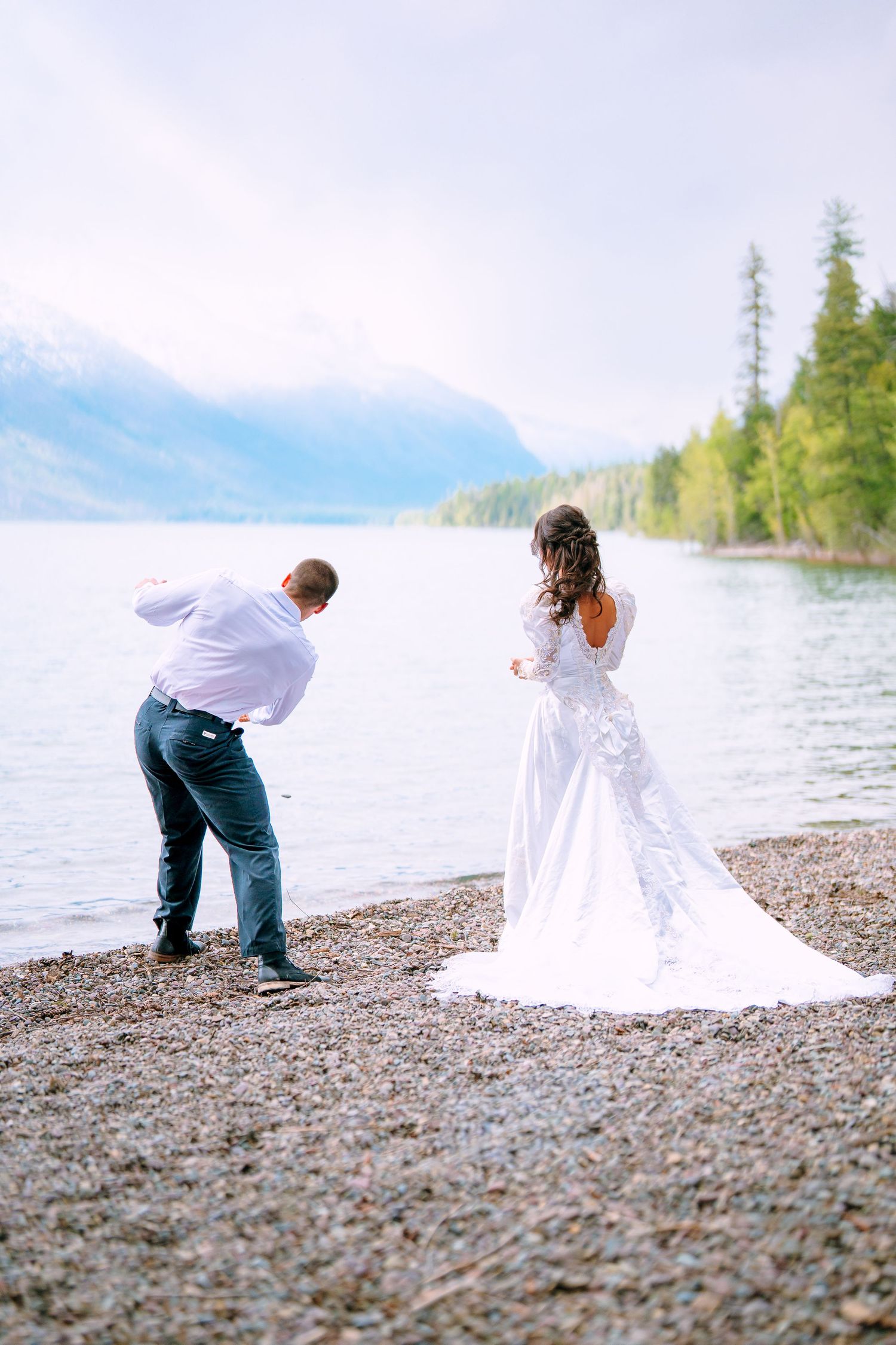 Couple embracing adventure during a lakeside Glacier National Park elopement.