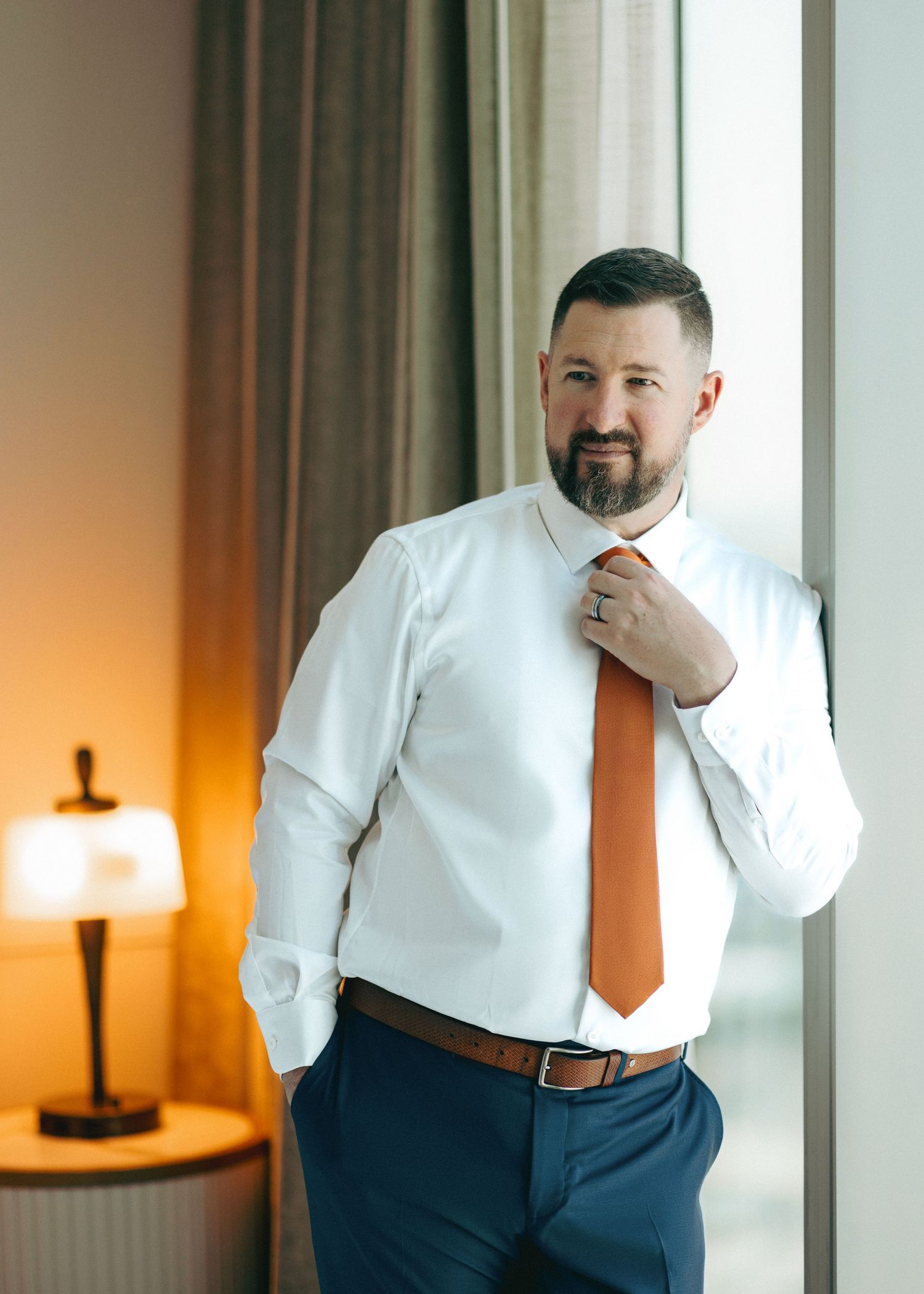 Professional portrait series showing a person in a white dress shirt and navy pants against a warm interior backdrop.