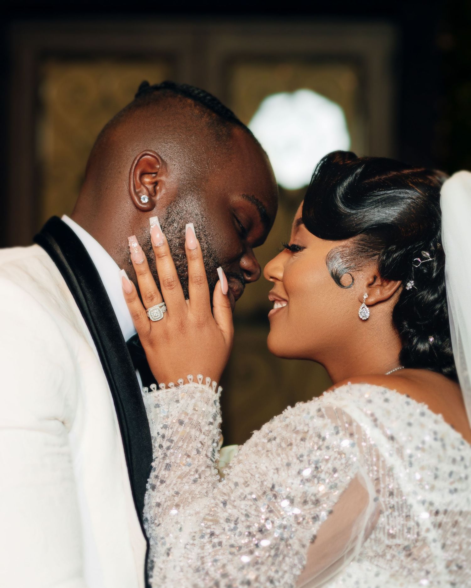 Romantic wedding couple sharing an intimate moment in formal attire.