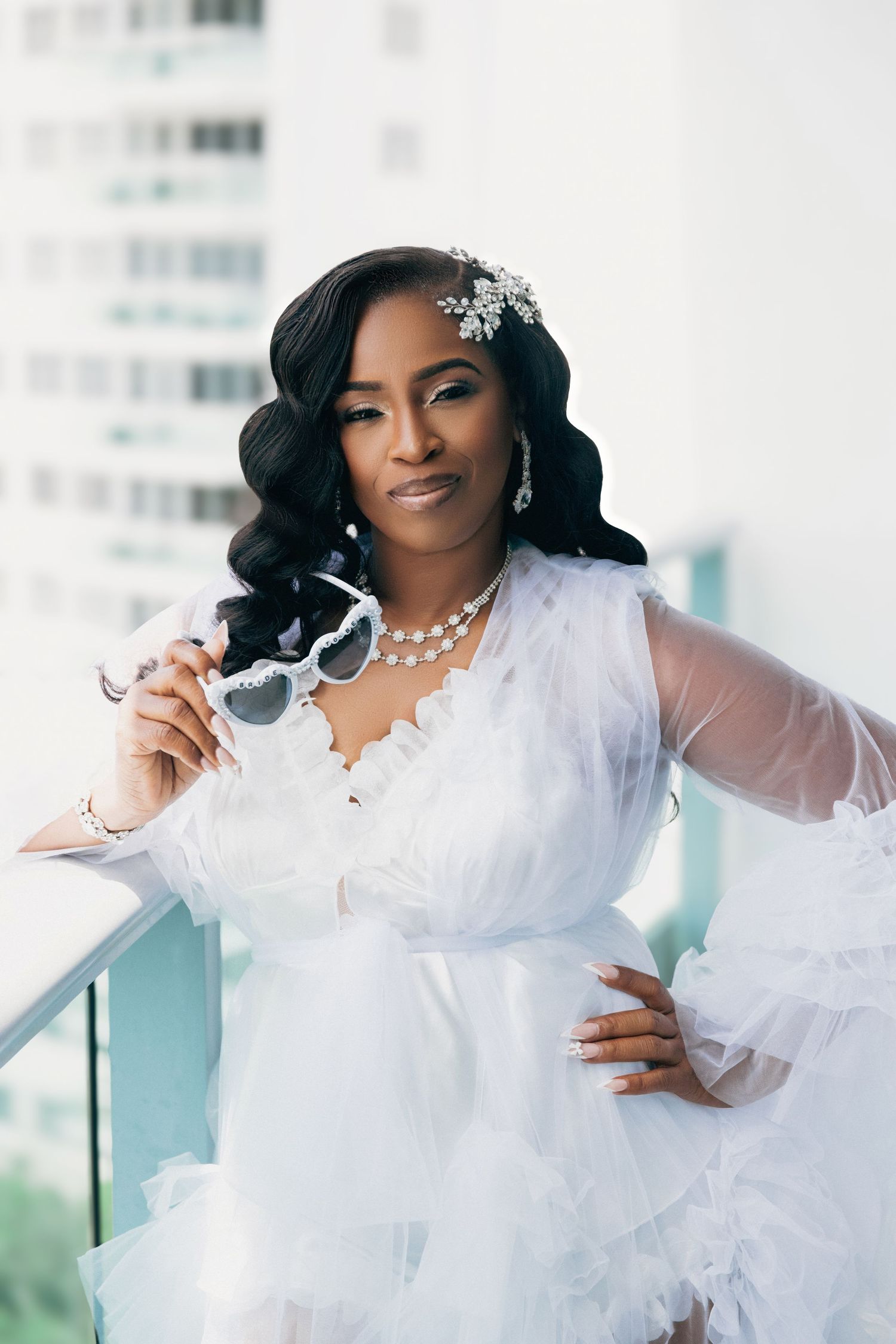 Glamorous bridal portraits featuring a white ruffled gown and pearl accessories.