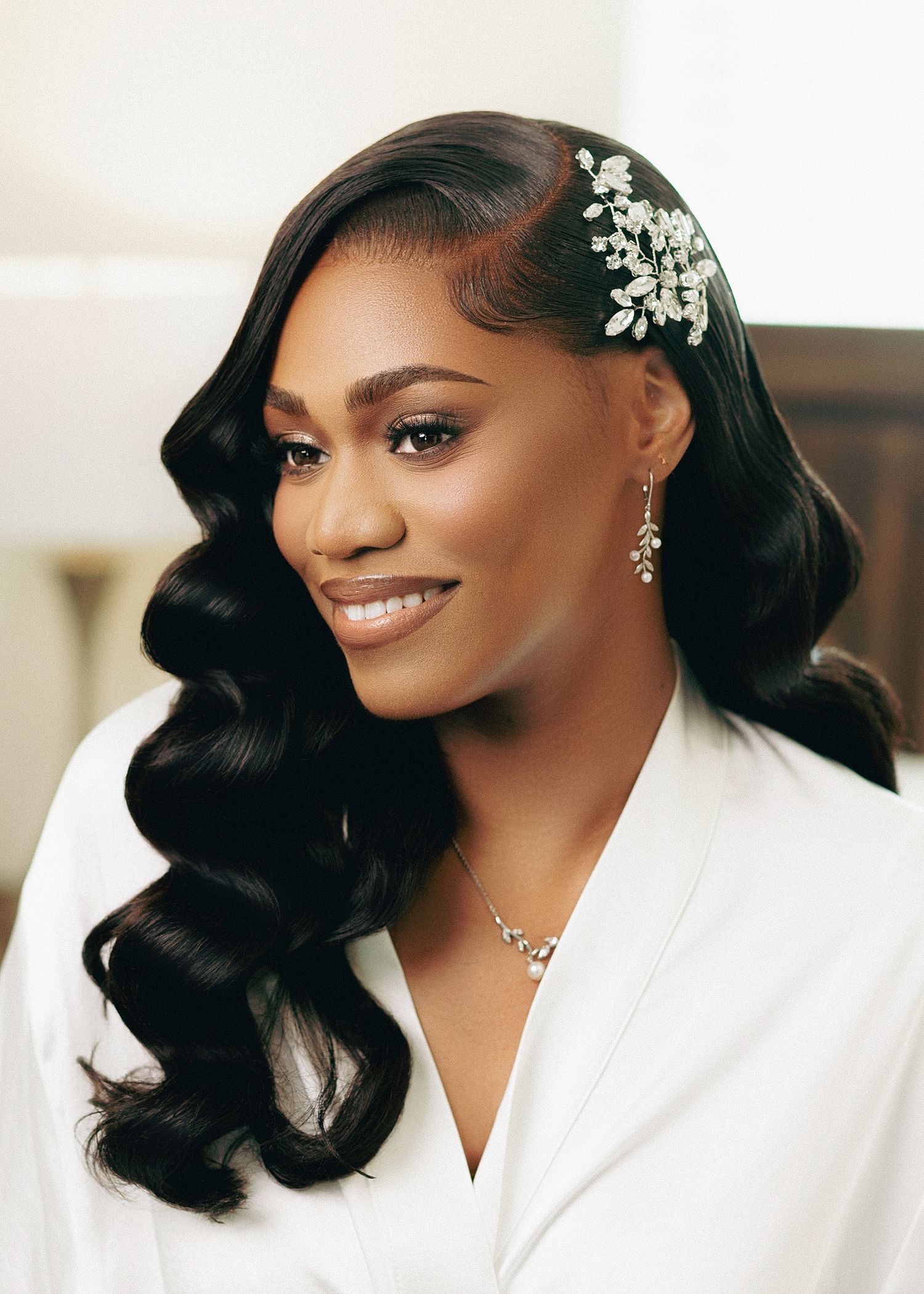 Elegant bridal portrait showcasing glamorous Hollywood waves hairstyle with crystal hair accessory and delicate jewelry.