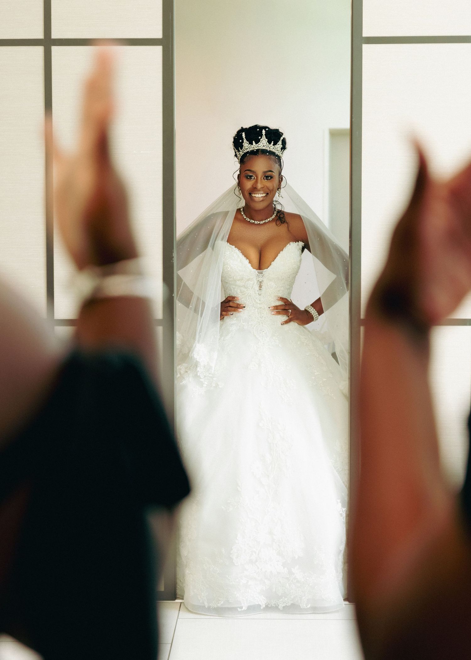 Beautiful white wedding dress displayed in modern interior with sliding doors.