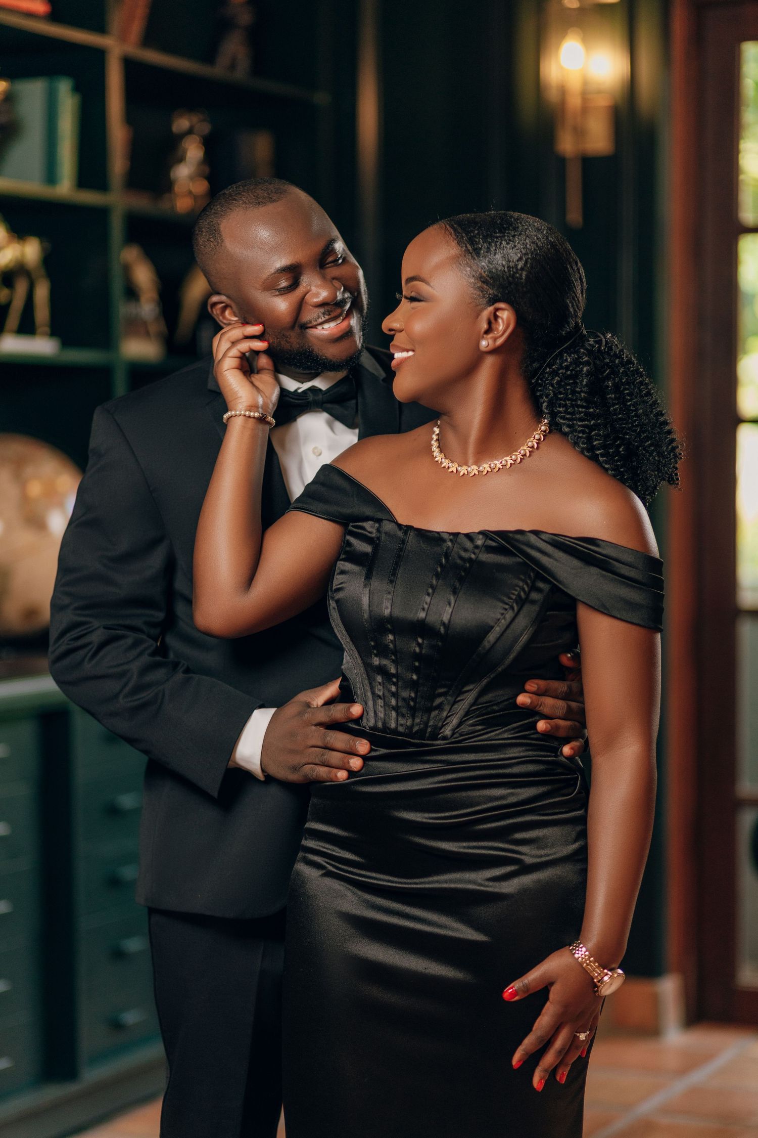 Couple in formal black attire shares intimate dance poses.