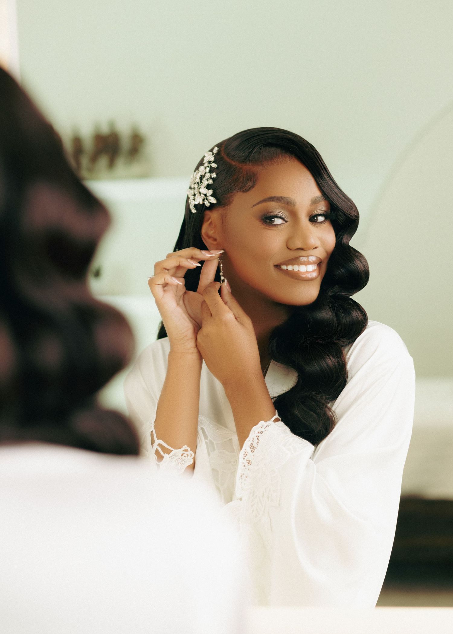 A bride wearing a white dress and glamorous hairstyle poses elegantly in a series of wedding portraits.