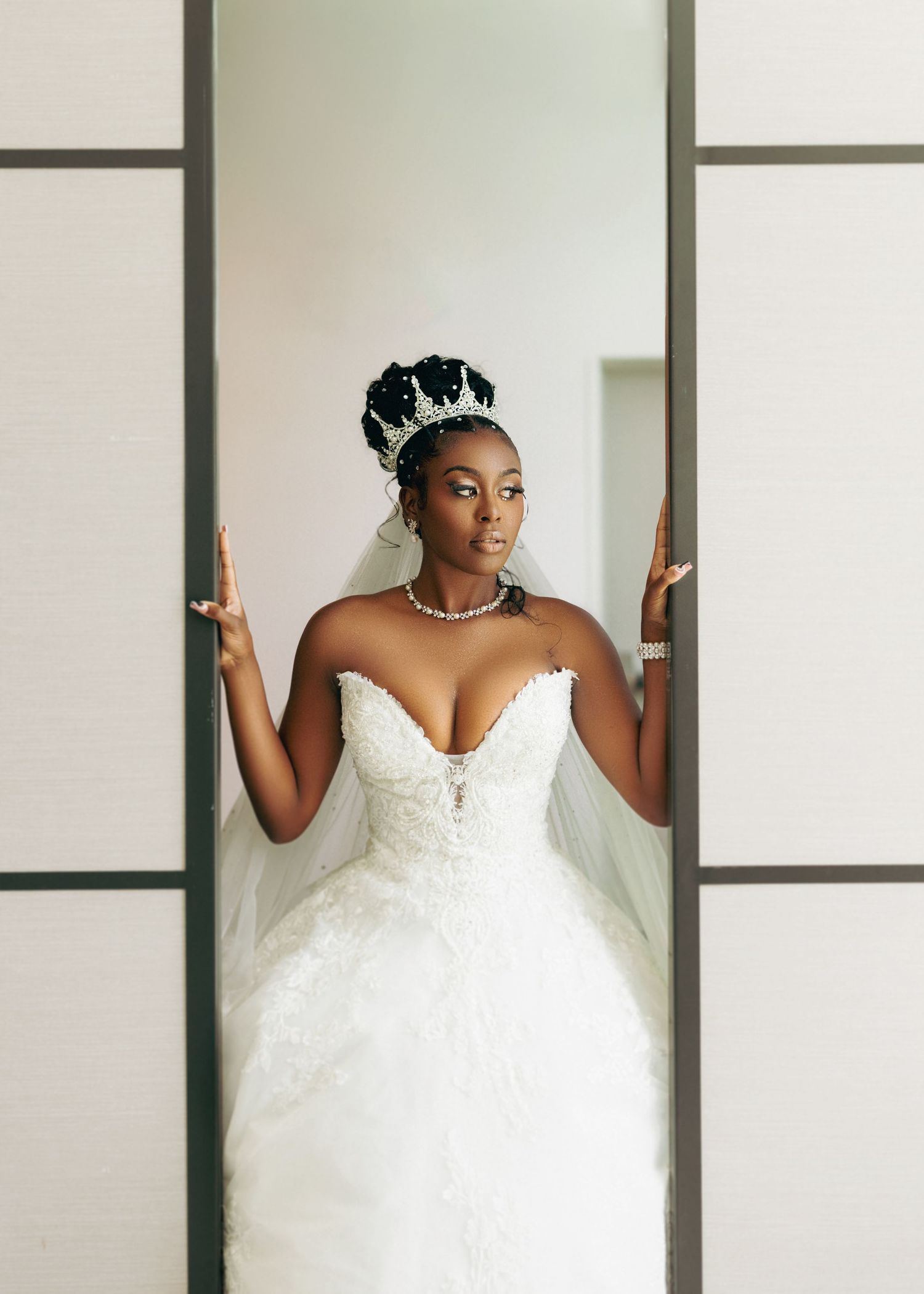 Stunning white wedding gown with sweetheart neckline and full skirt photographed against minimalist backdrop.