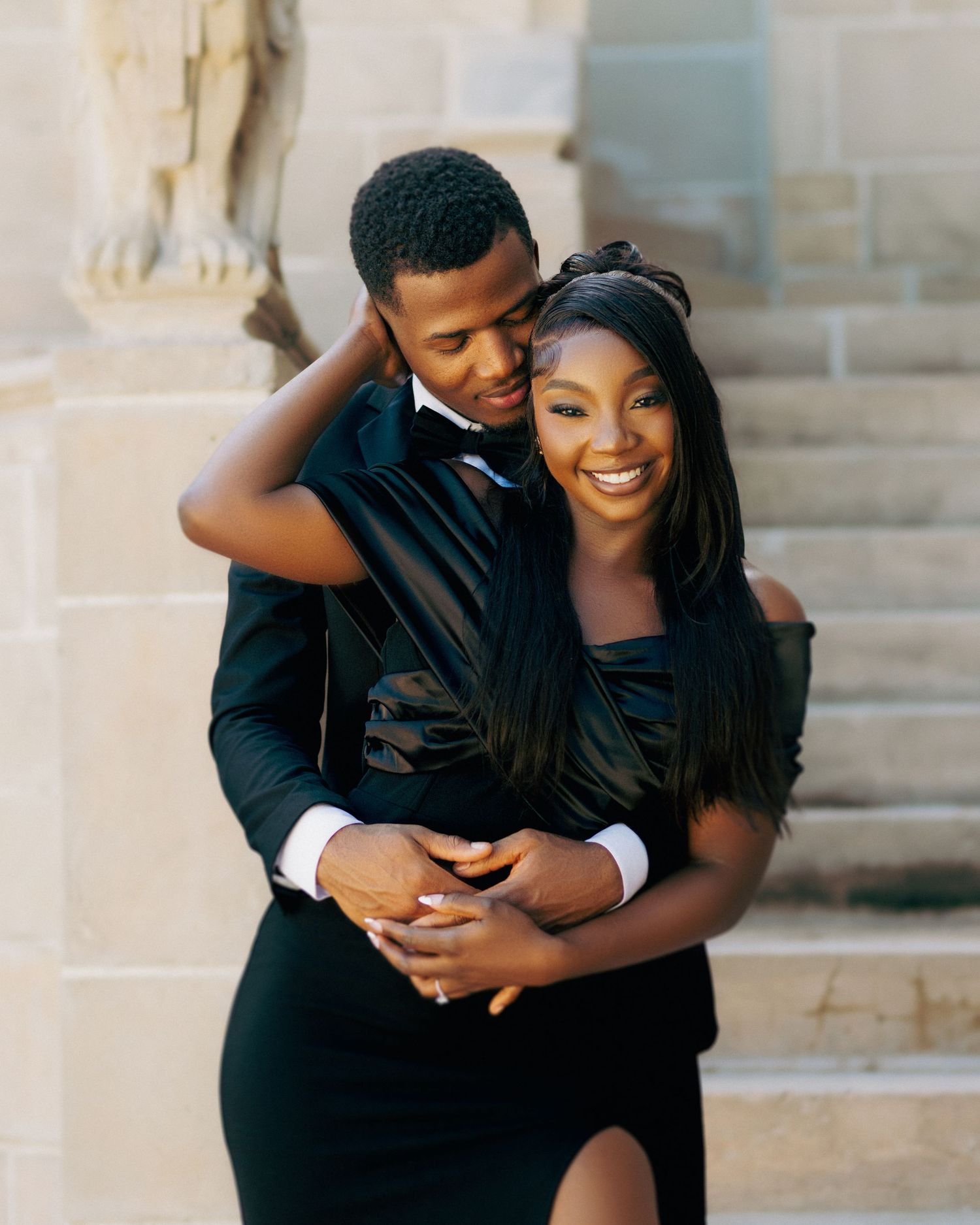 Joyful couple embracing and laughing together during an outdoor photoshoot.